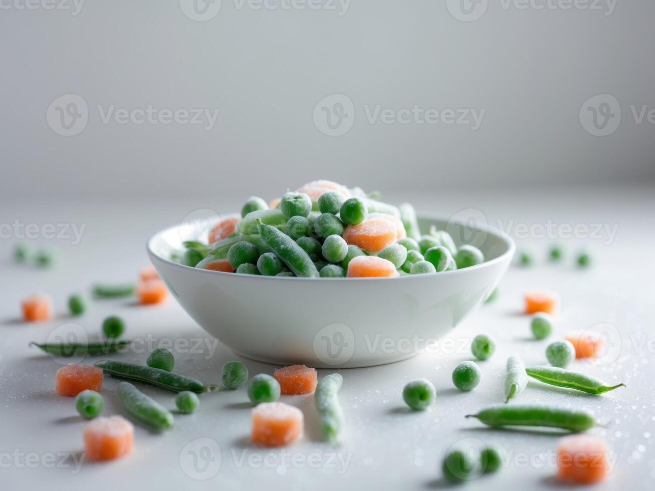 A bowl of peas and carrots on a white table photo