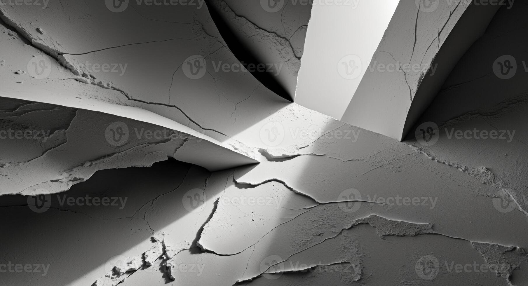 A black and white photo of a wall with cracks