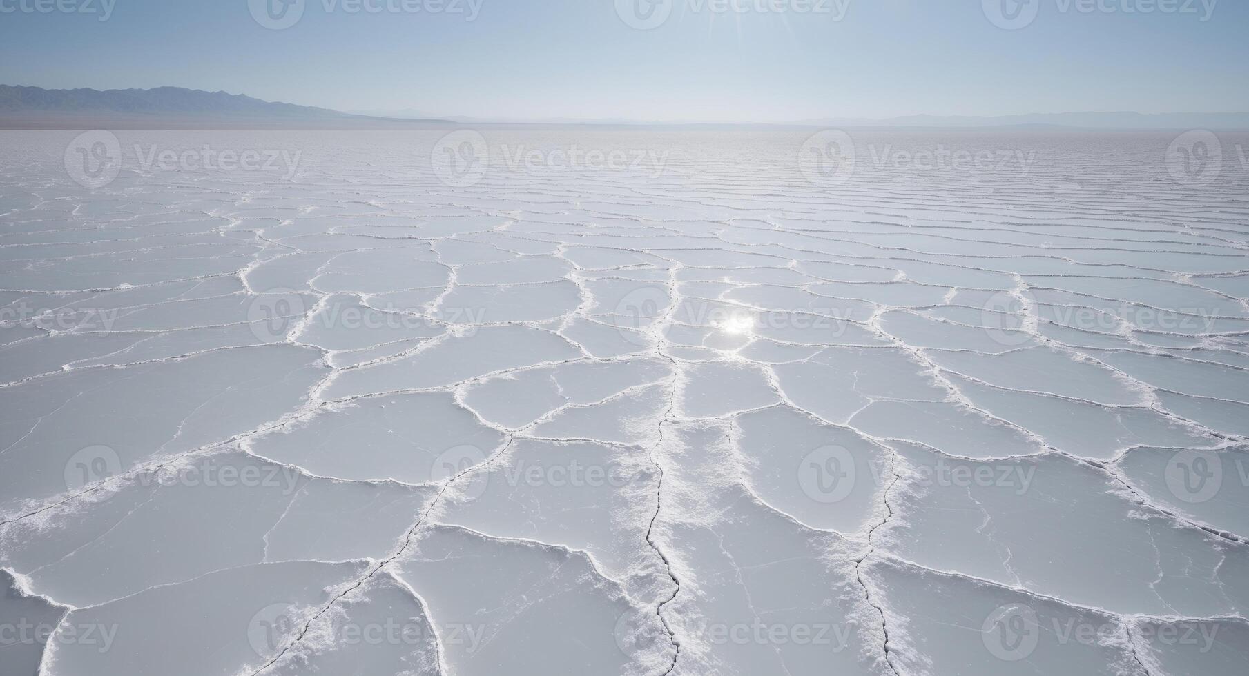 The sun shines over the salt flats of the salar de uyuni photo