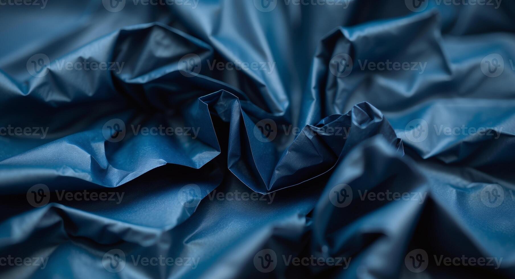 Abstract Closeup of Crumpled Blue Fabric, Revealing Rich Textures and Deep Shadows. photo