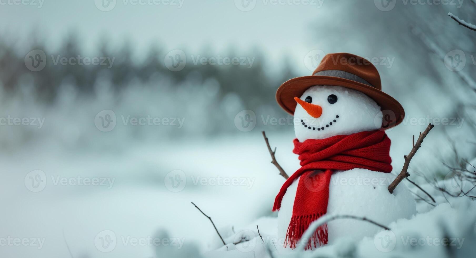 A whimsical snowman wearing a hat and red scarf stands in a snowy winter landscape. photo