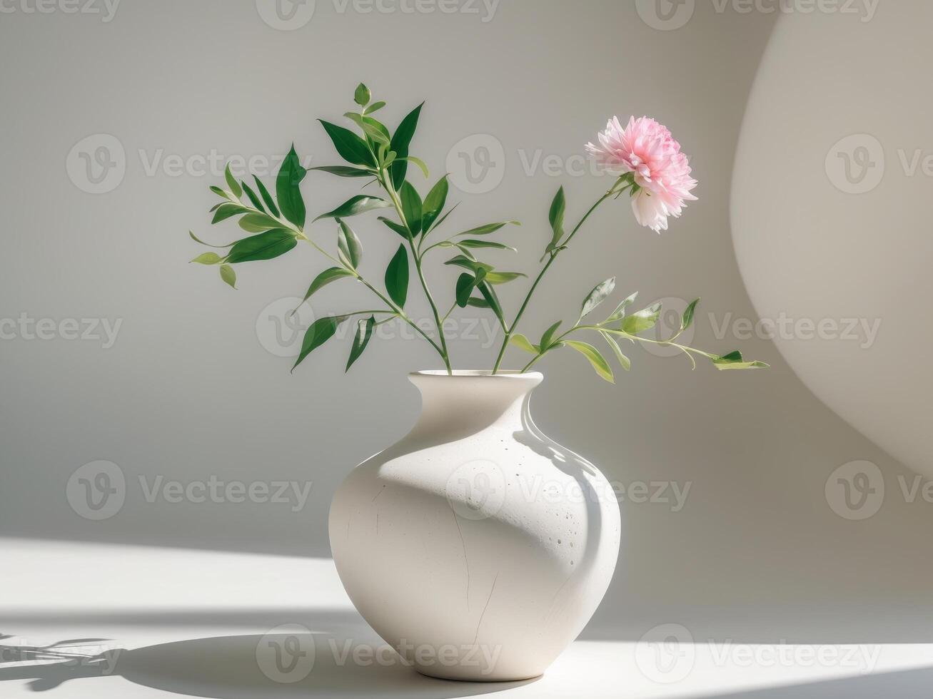 A white vase with pink flowers in it photo