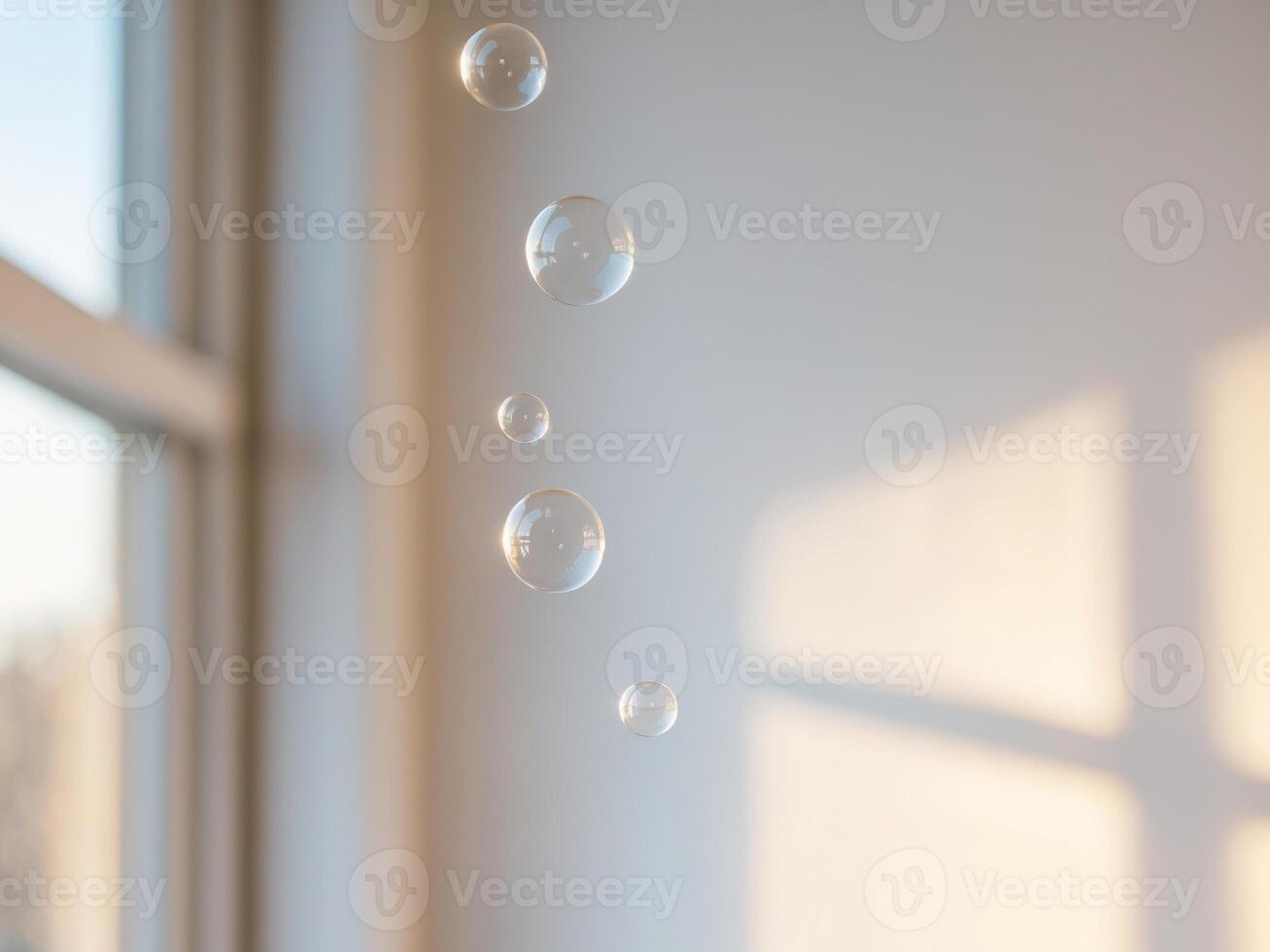 Soap bubbles floating in the air near a window photo