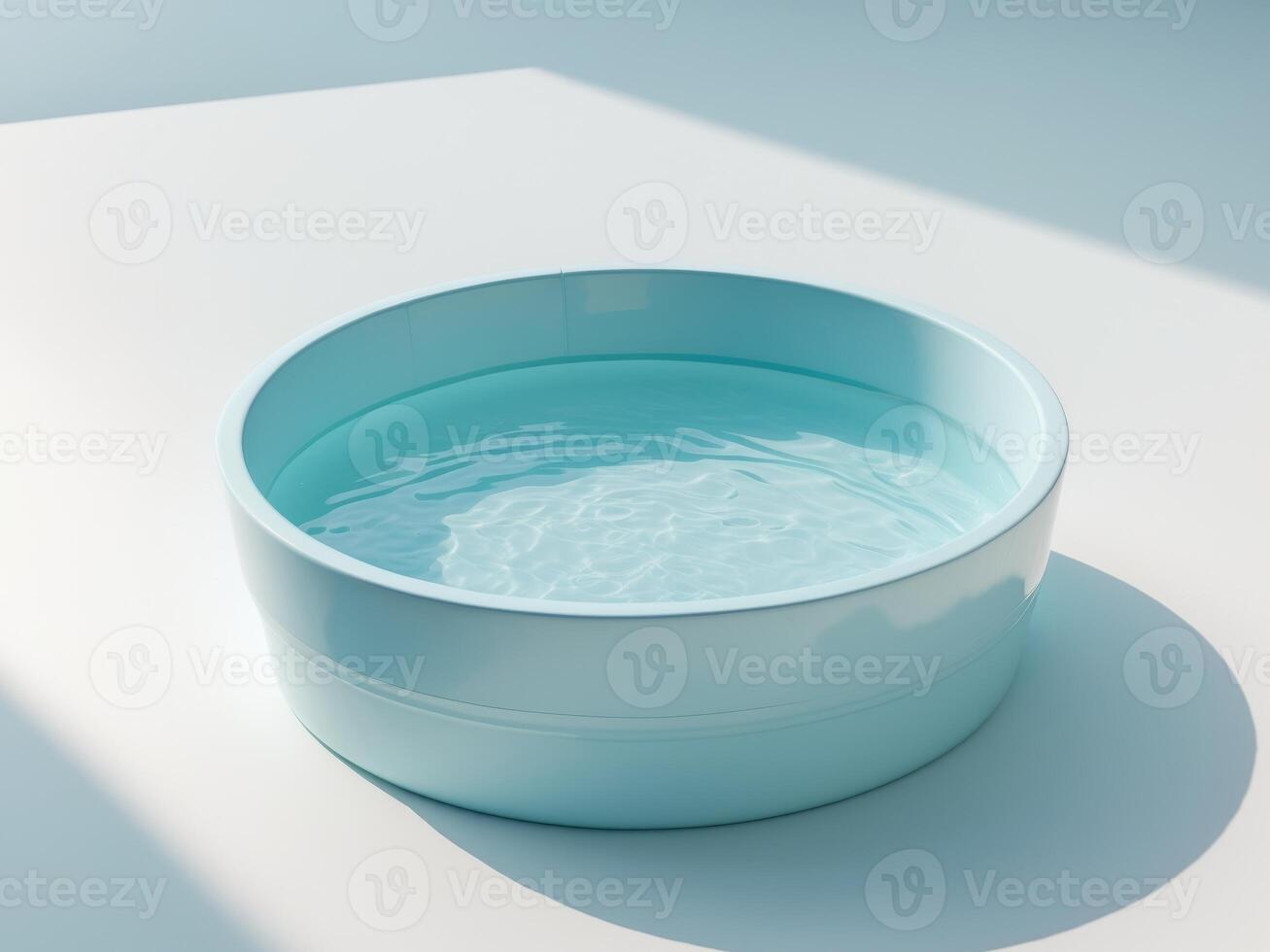 A blue bowl with water in it on a white surface photo