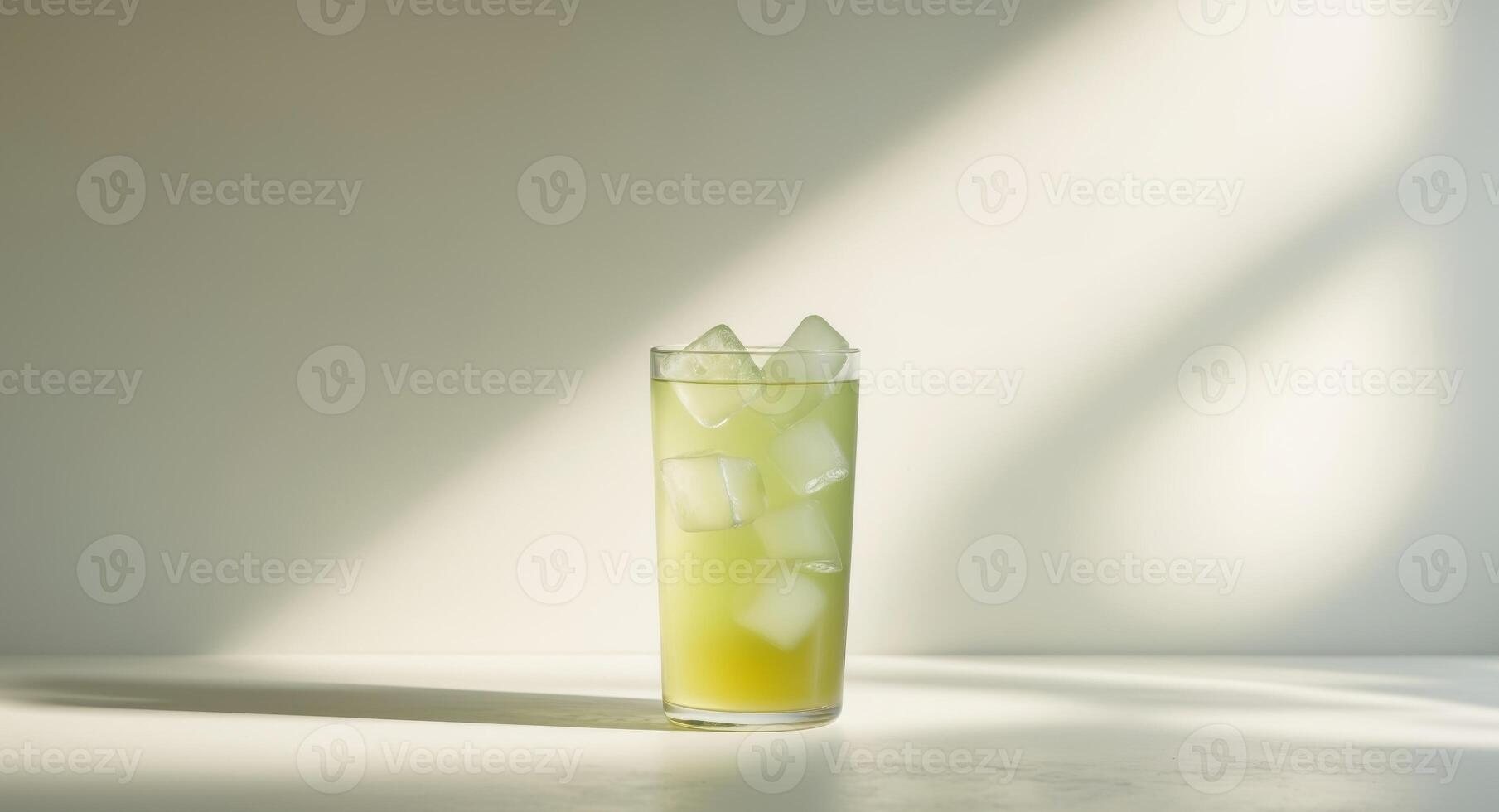 Refreshing Green Juice with Ice Cubes in a Glass on a Bright Background, Summer Time. photo