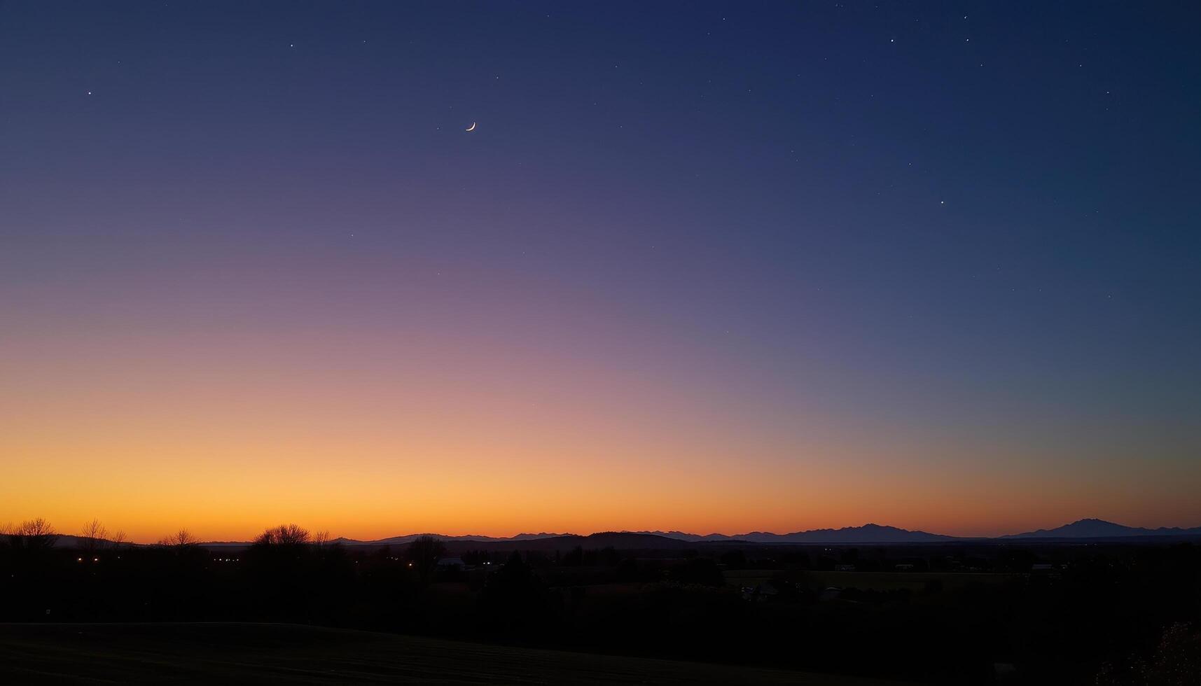 a faint glow appears on the horizon as twilight fades into night. photo