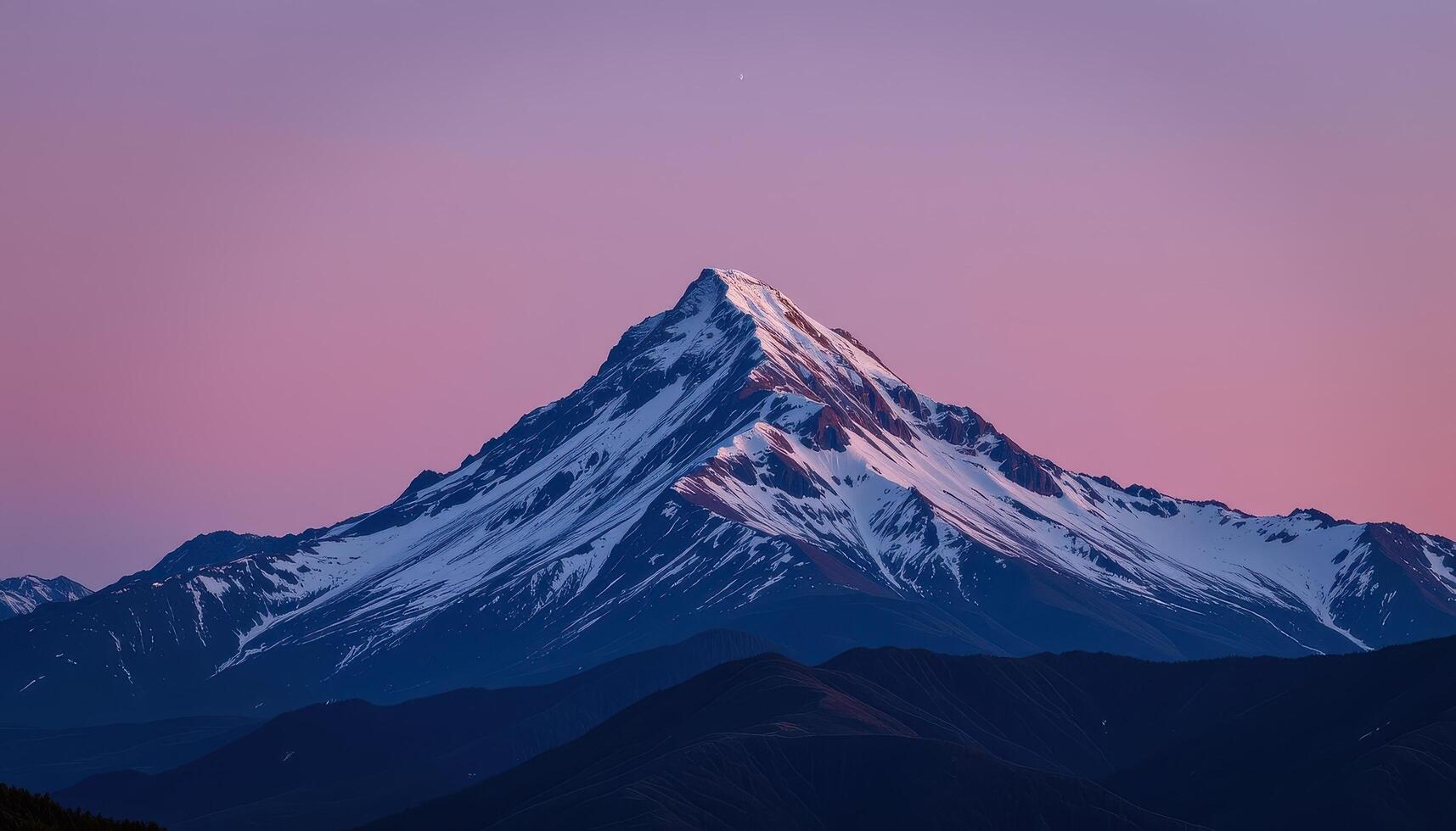 a ridge of ice gleams in the moonlight atop a remote mountain. photo