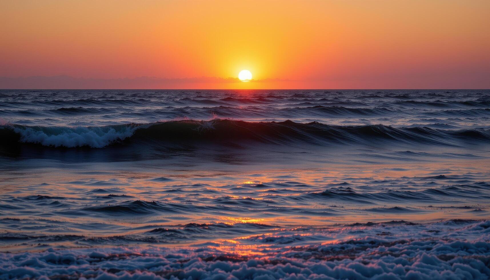 the sun dips below the horizon, casting the ocean in hues of violet and gold. photo