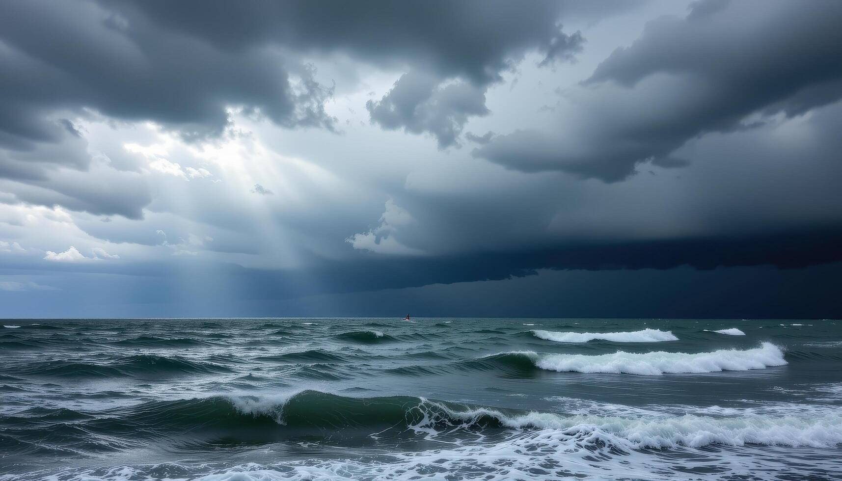 a storm brews over the sea, turning the sky to swirling silver and charcoal. photo