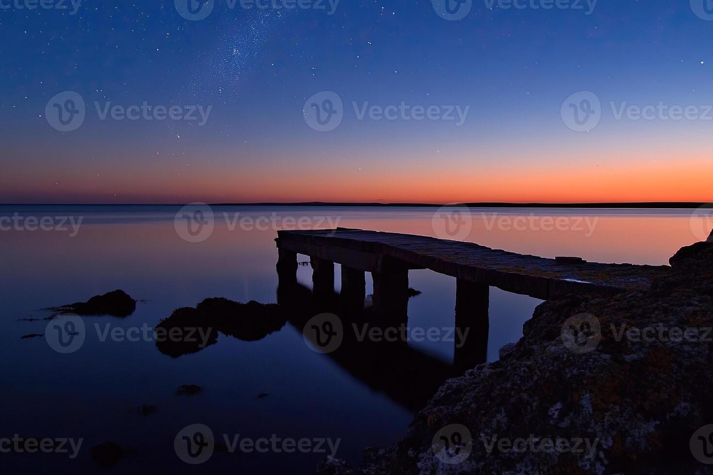 A pier at dusk with the milky in the sky photo