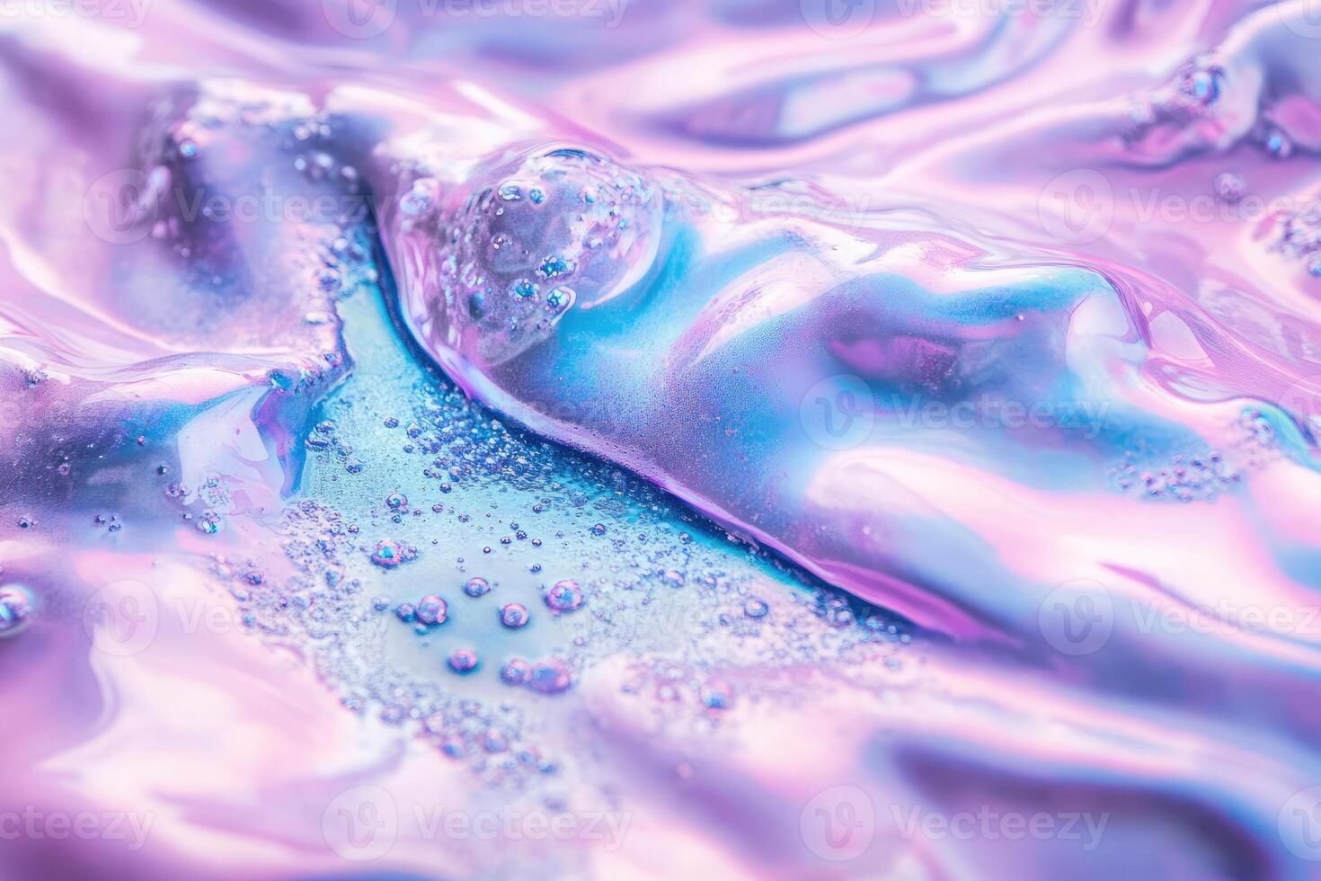 A close up of a liquid with bubbles and pink and blue colors photo