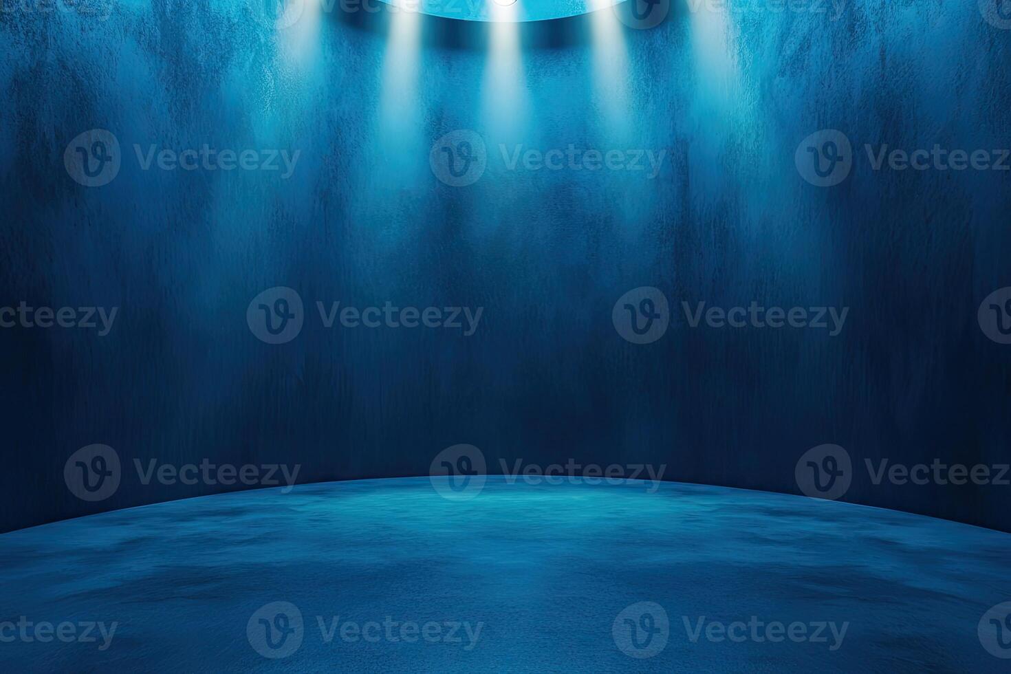 An empty room with a light coming from the ceiling photo