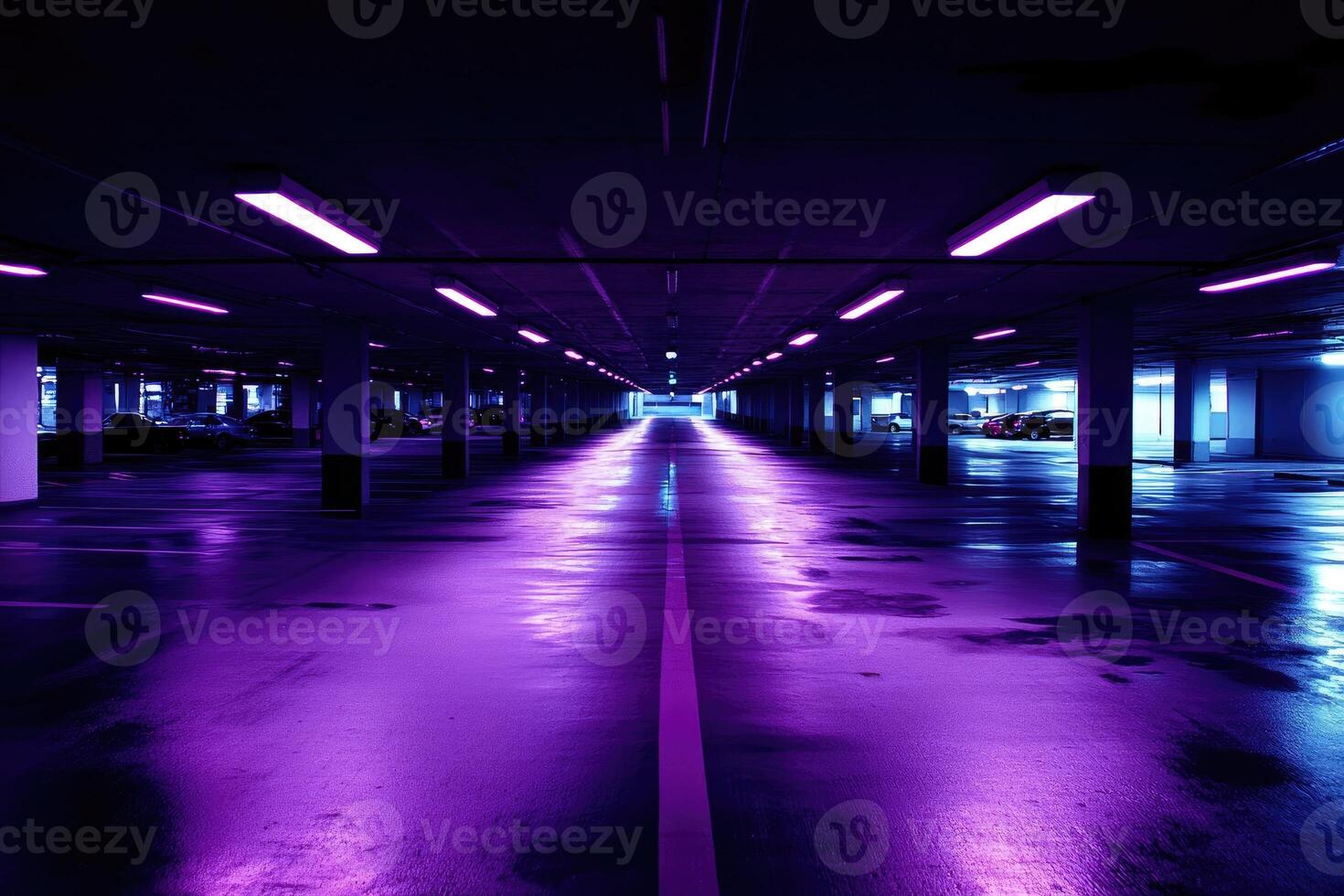 A purple light is shining on the floor of a parking garage photo