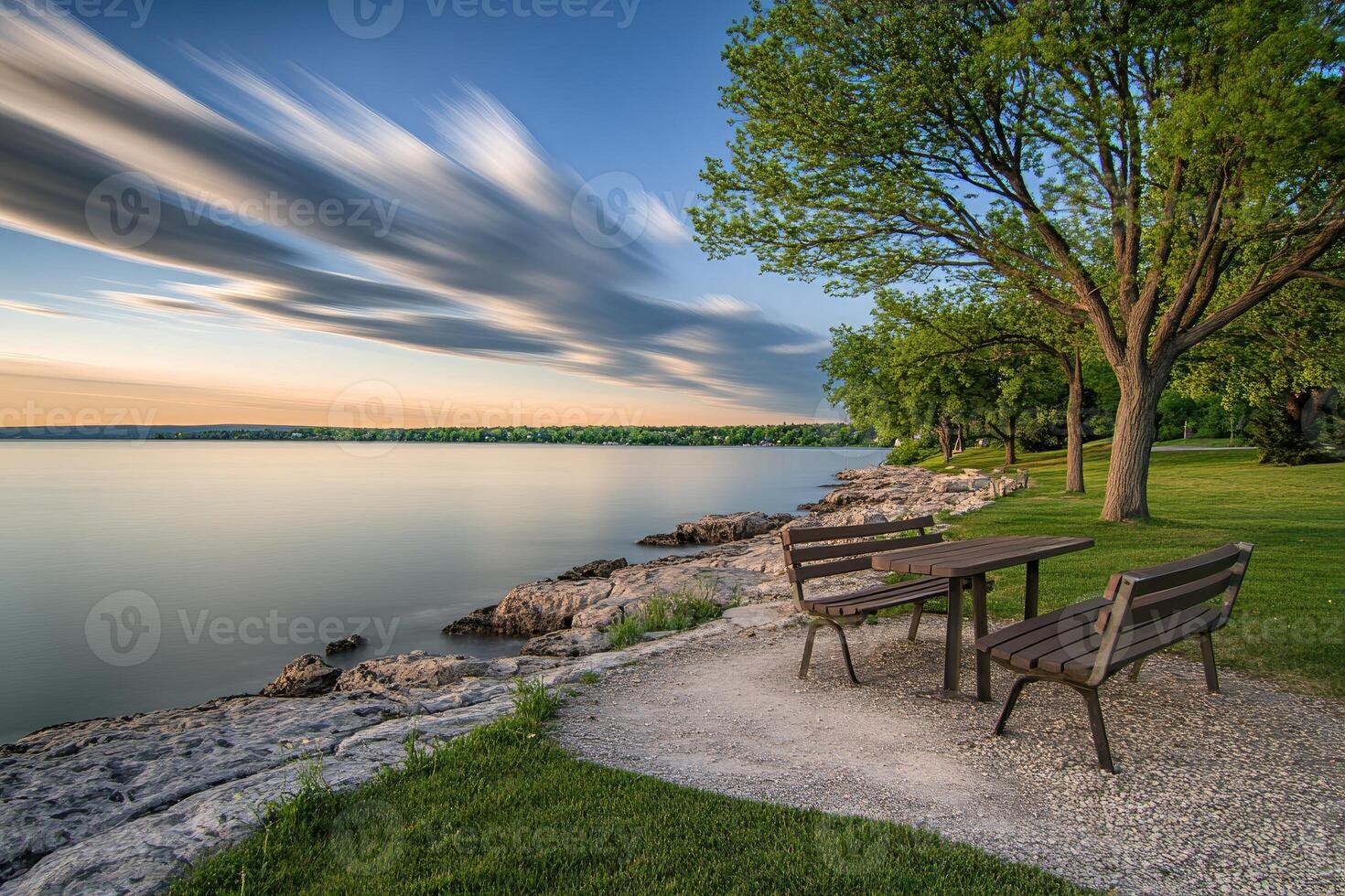 A bench and table sitting on a grassy area photo