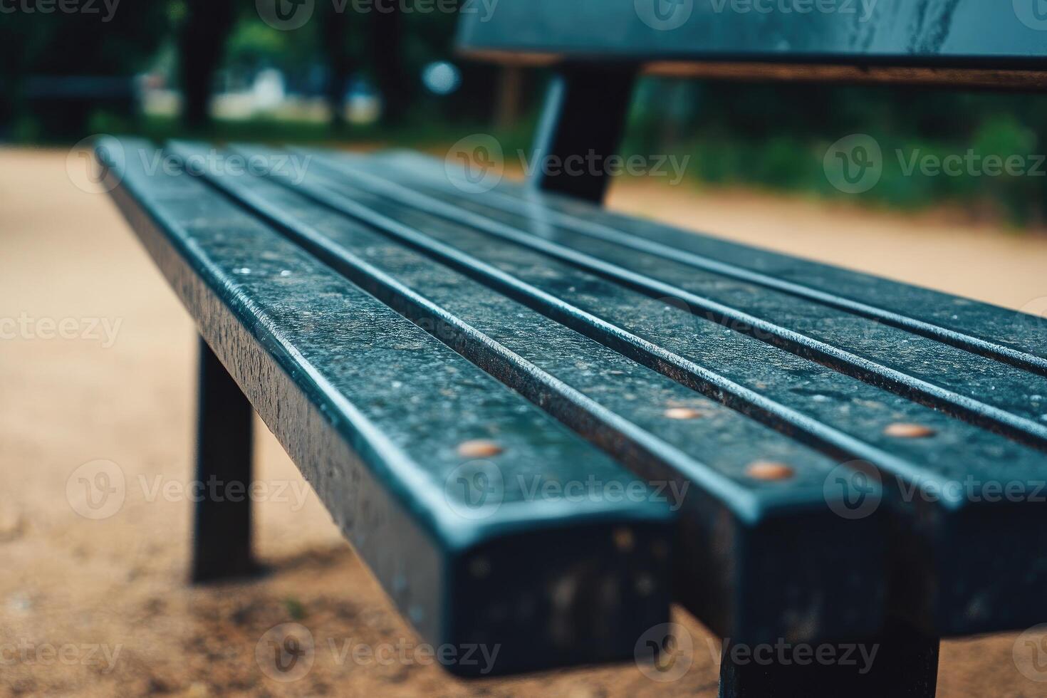 A bench with a wet seat and a dirt ground photo