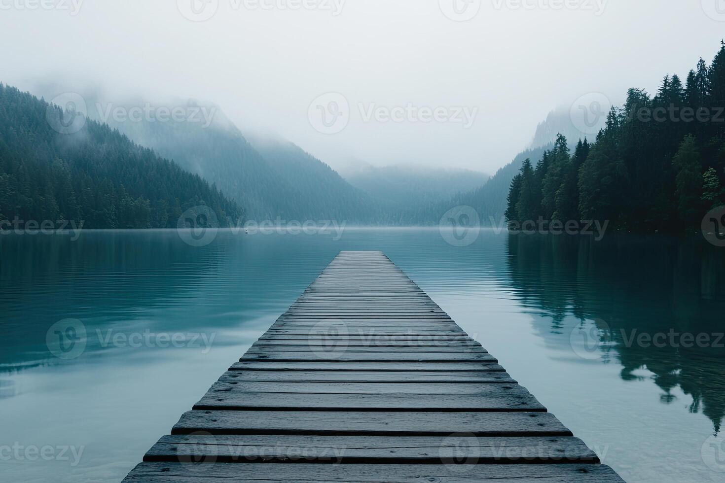 A long wooden pier leads into a lake photo