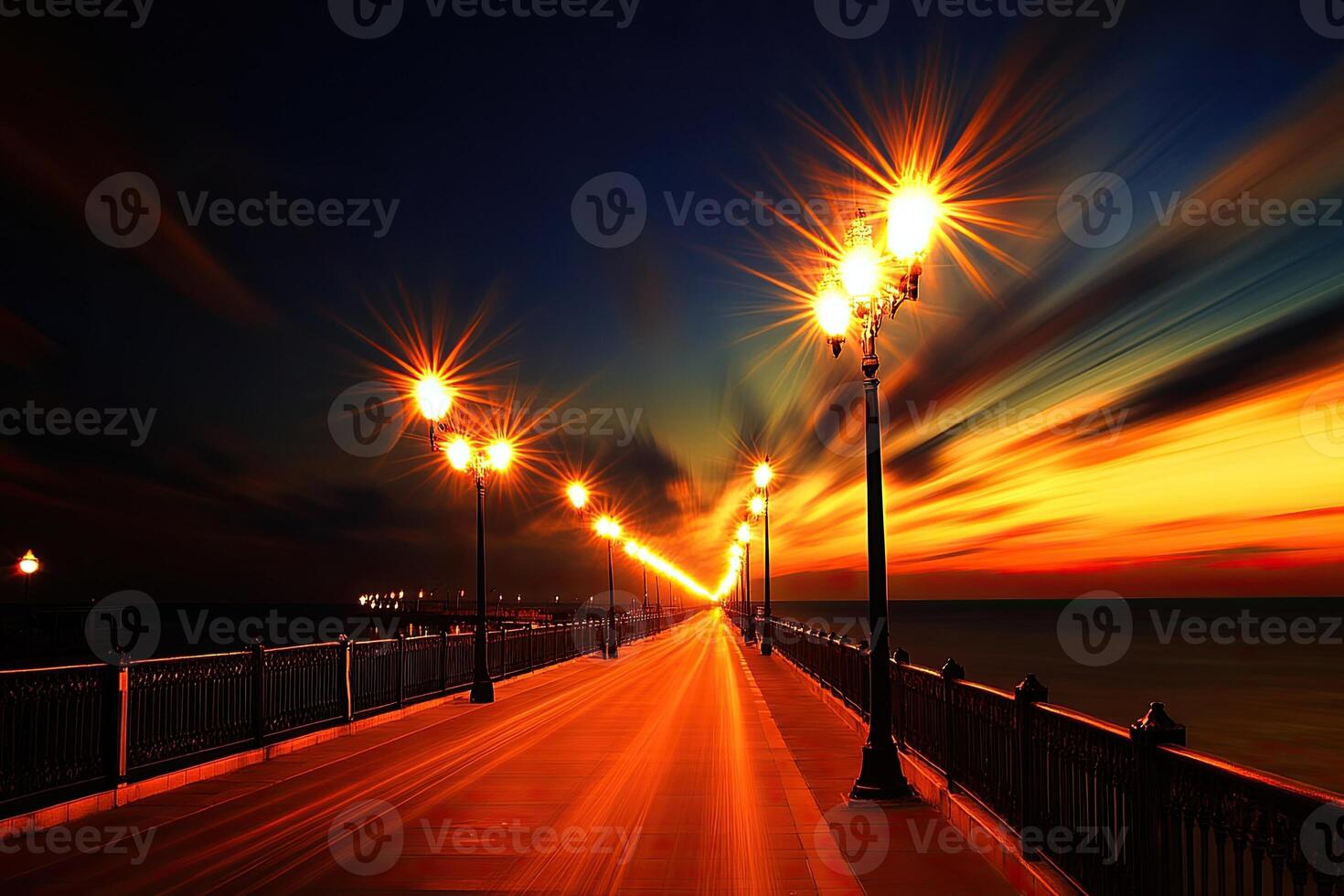 A long bridge with street lights at sunset photo