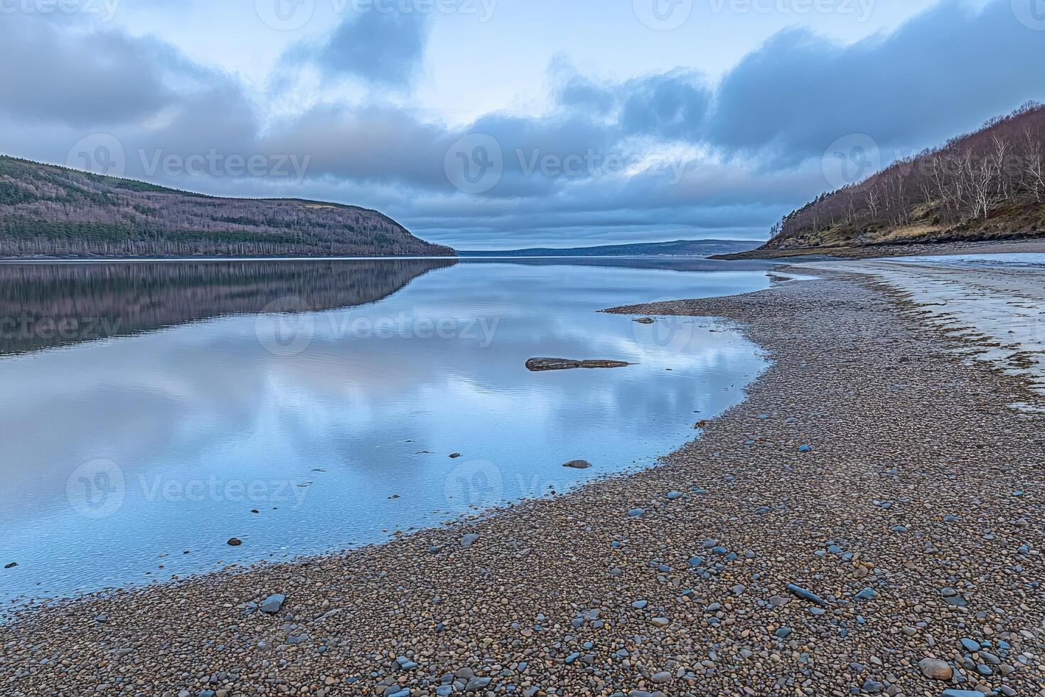 A lake with a small body of water on the shore photo