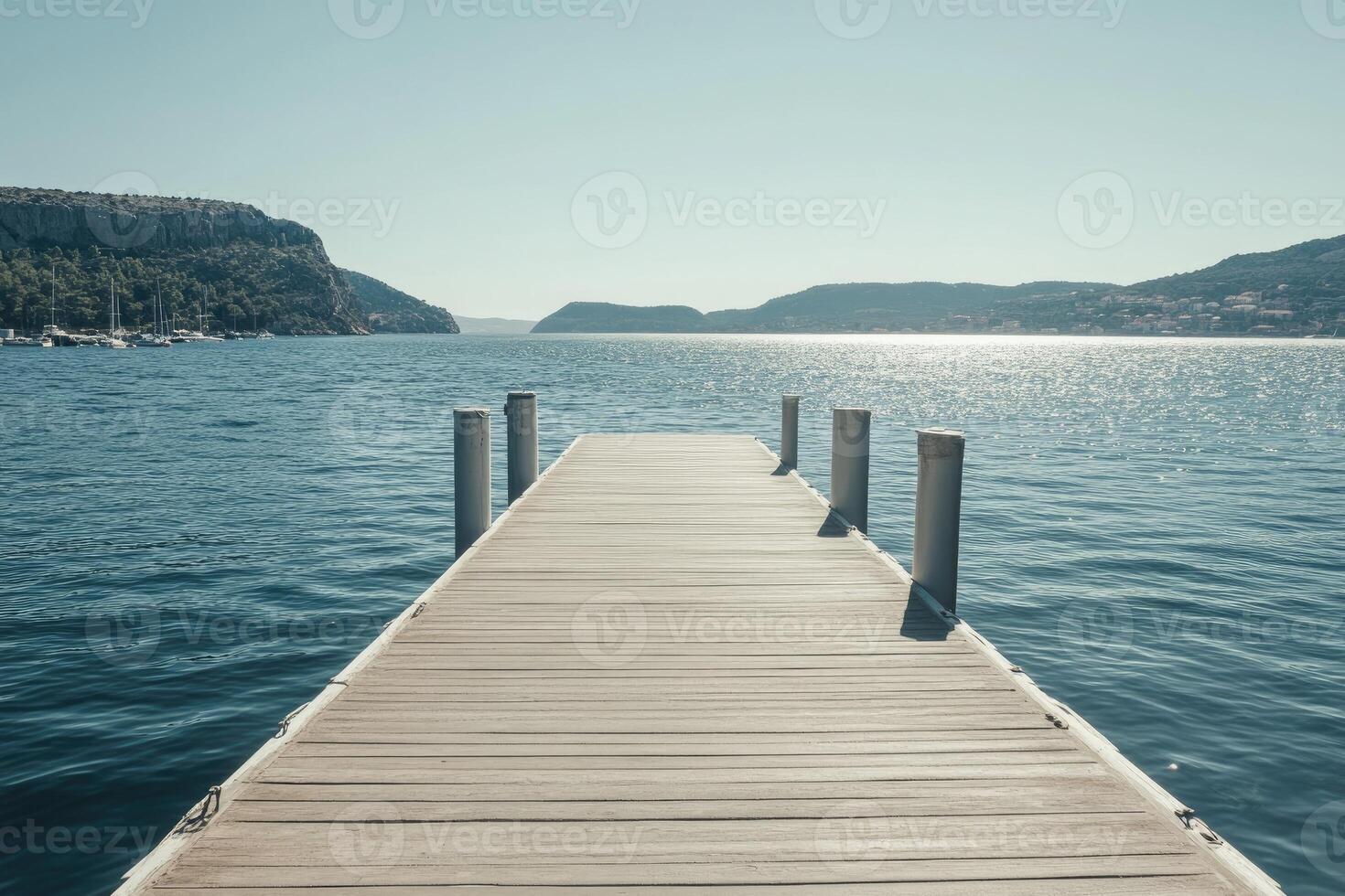 A wooden dock extends into the water photo