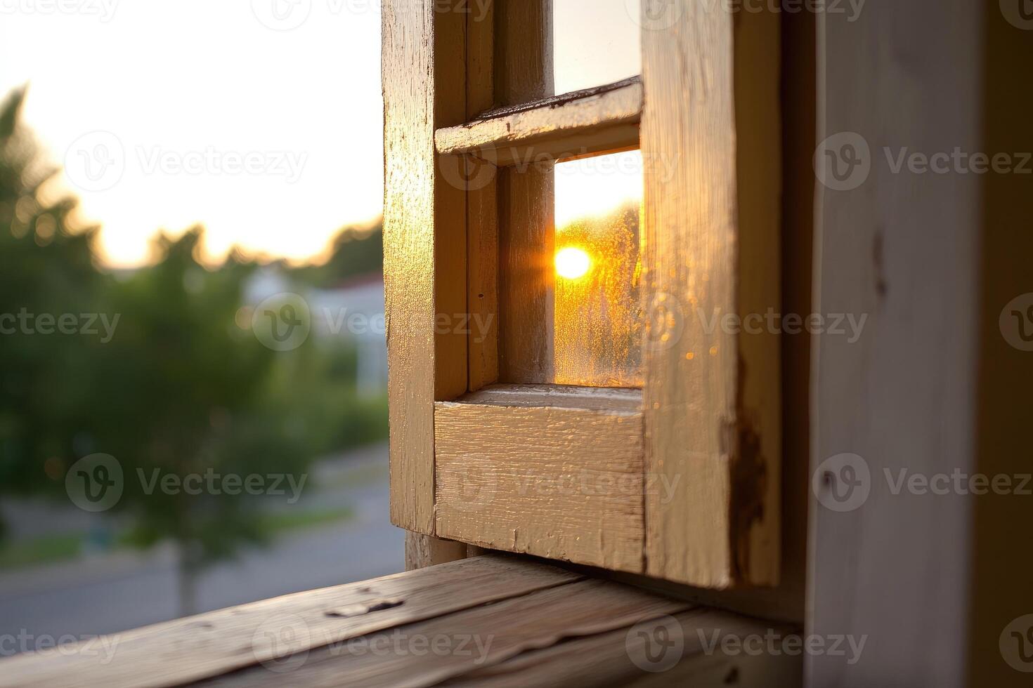 A wooden window with a sun setting behind it photo
