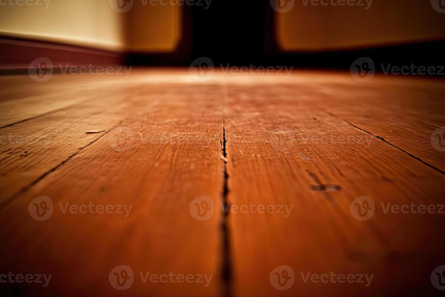 An empty wooden floor with a dark hallway photo