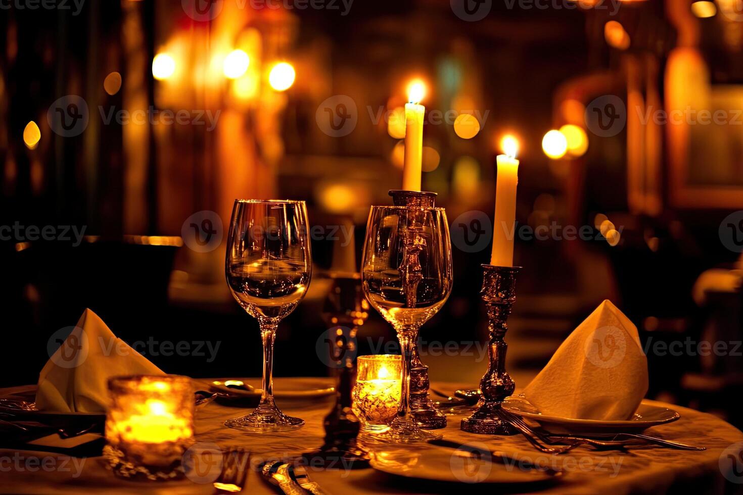 A table setting with candles and wine glasses photo