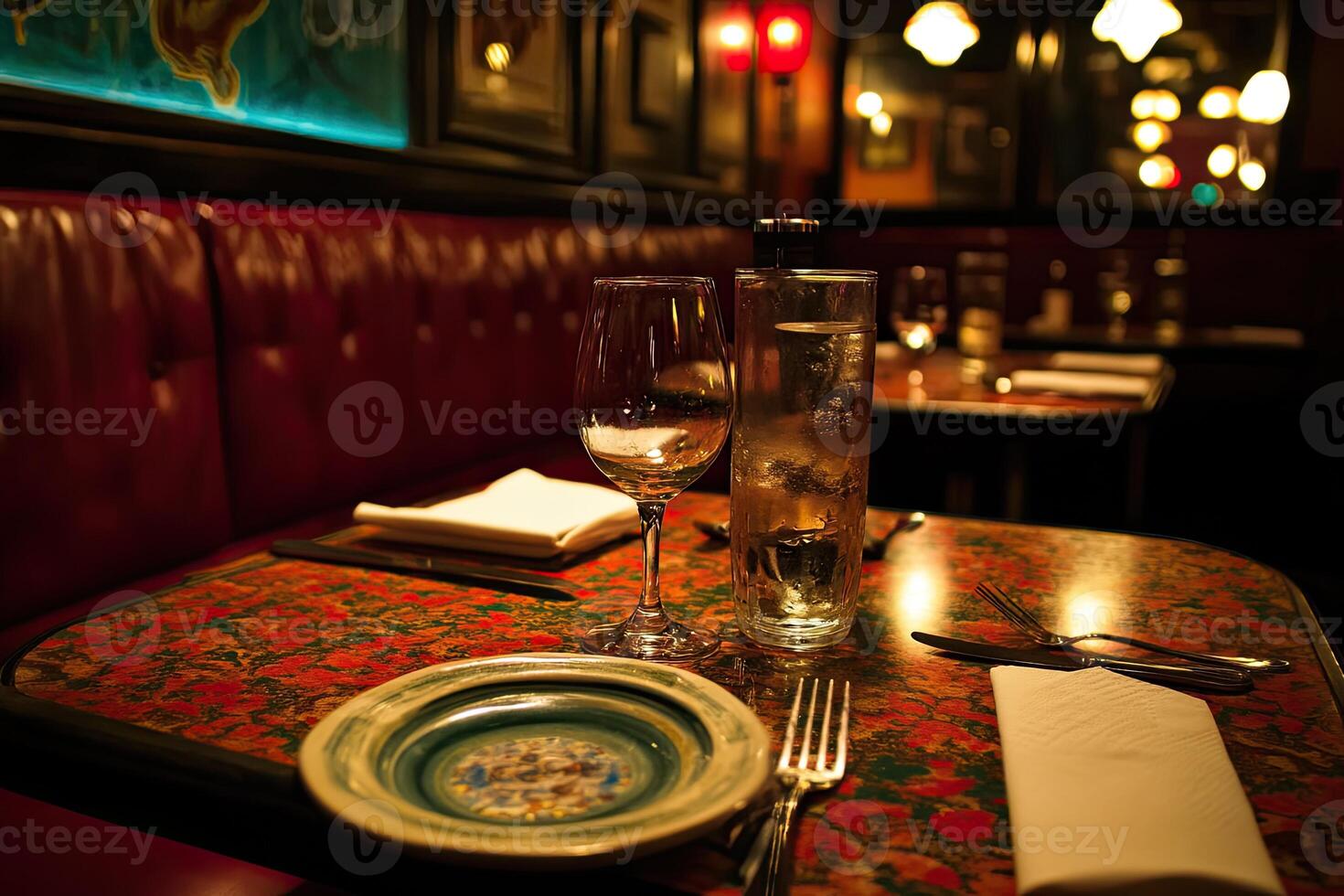 A table with a plate and wine glass on it photo
