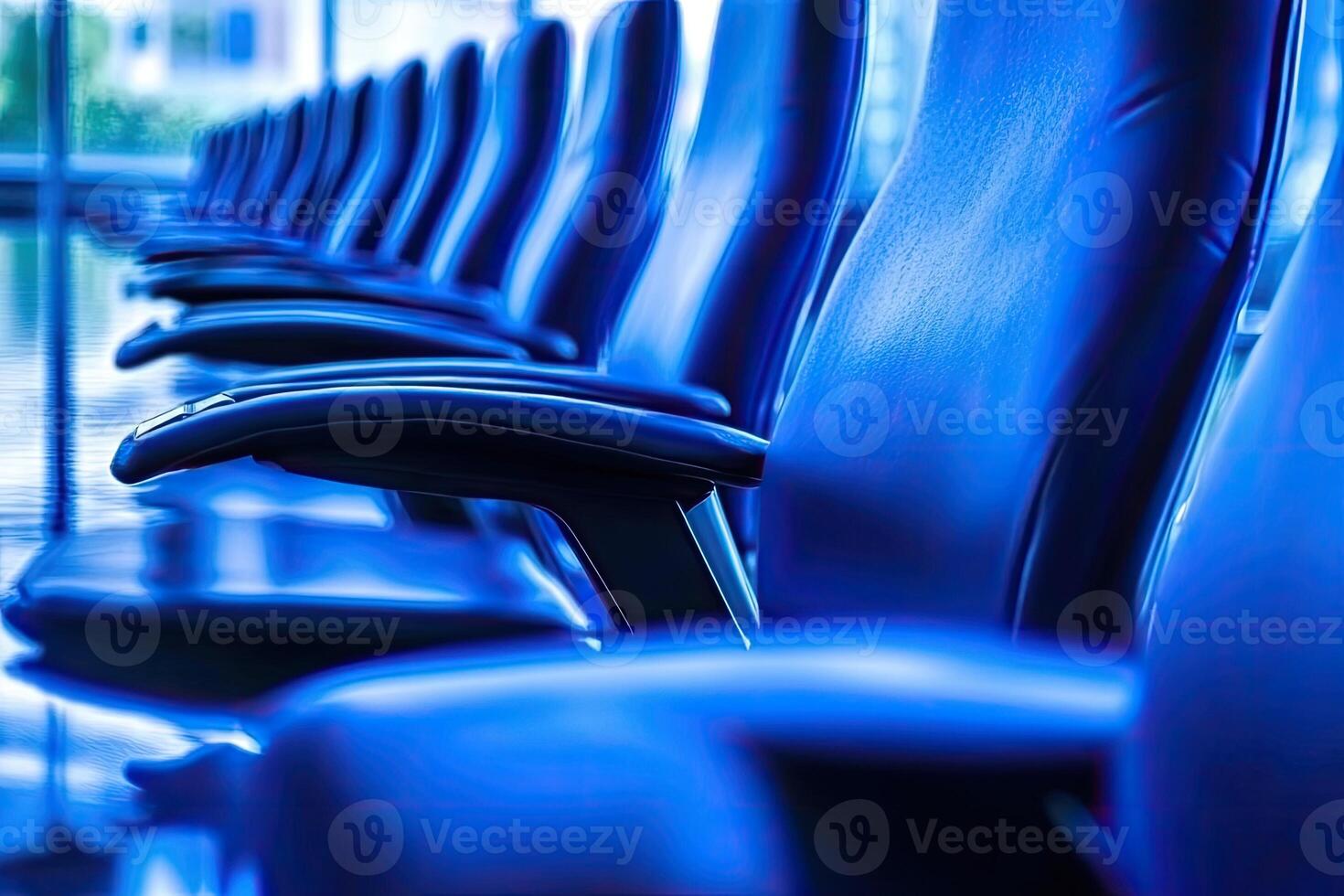 A row of blue chairs in an office building photo