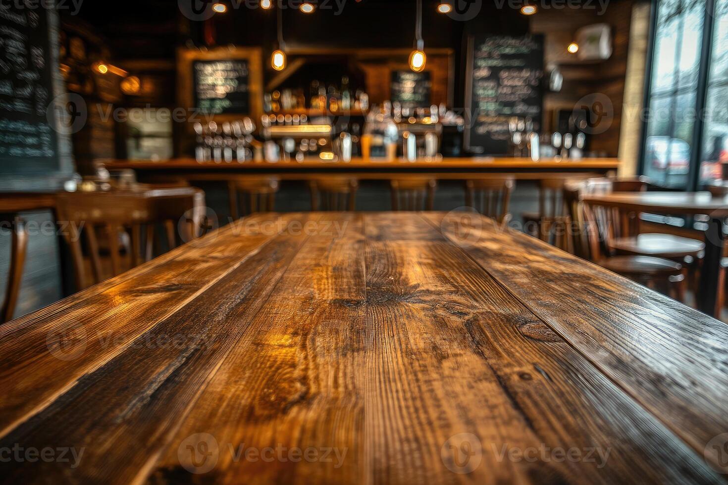 A wooden table in a restaurant with chairs photo