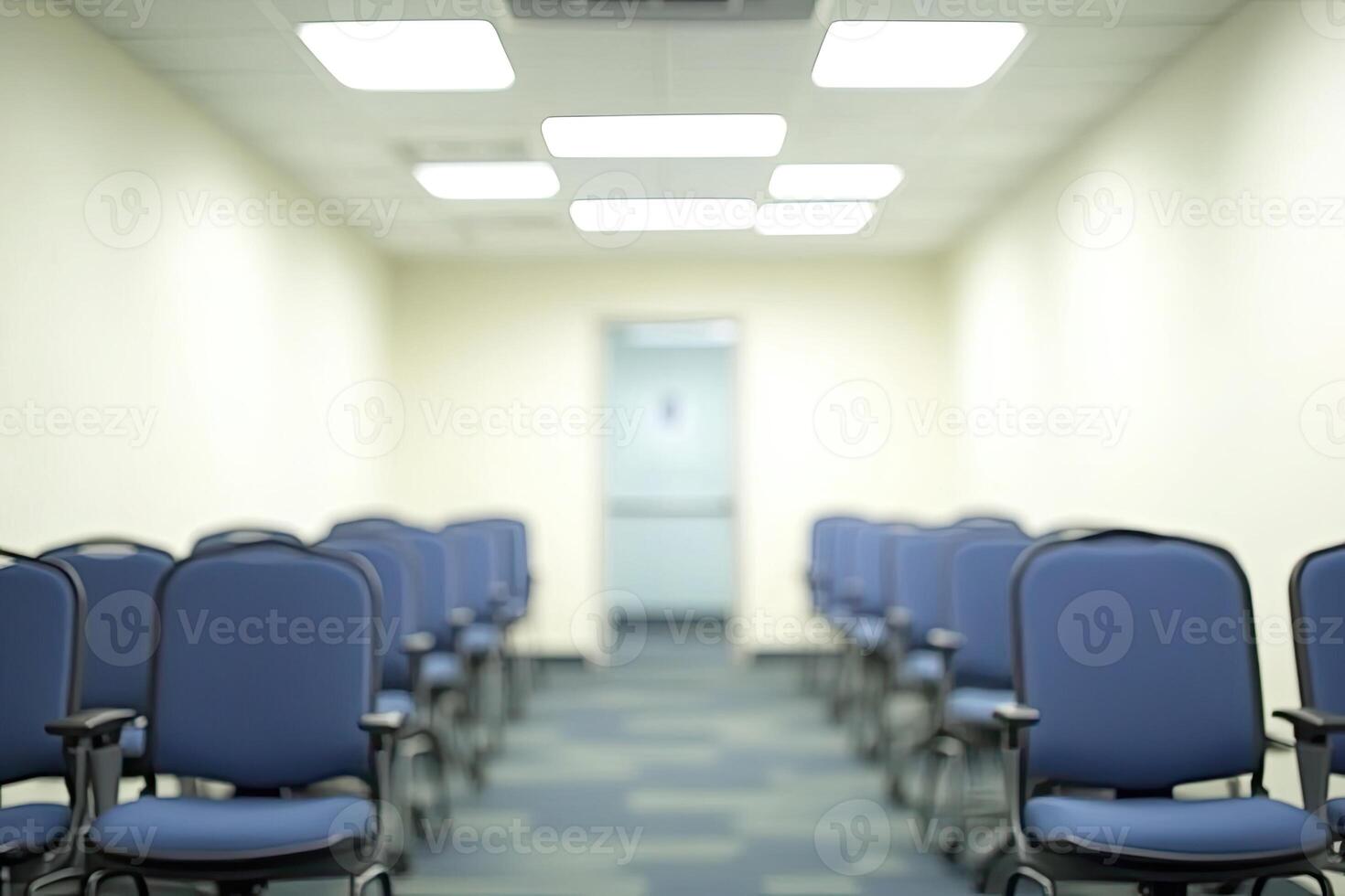 Empty chairs in a conference room with a white wall photo