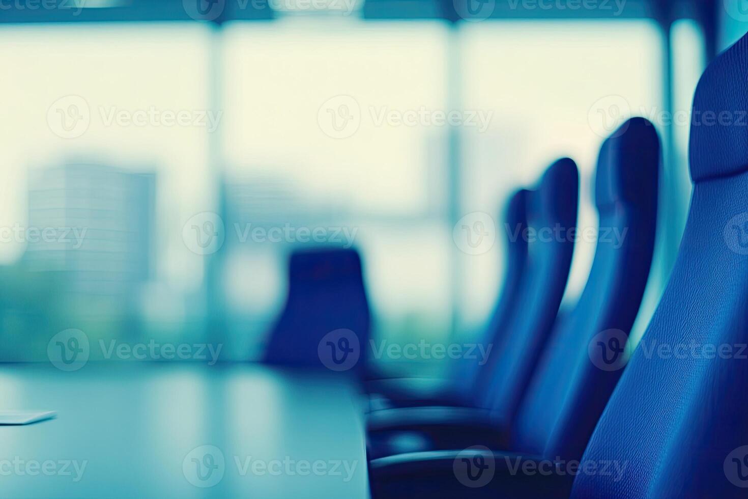 A conference room with chairs and a laptop photo