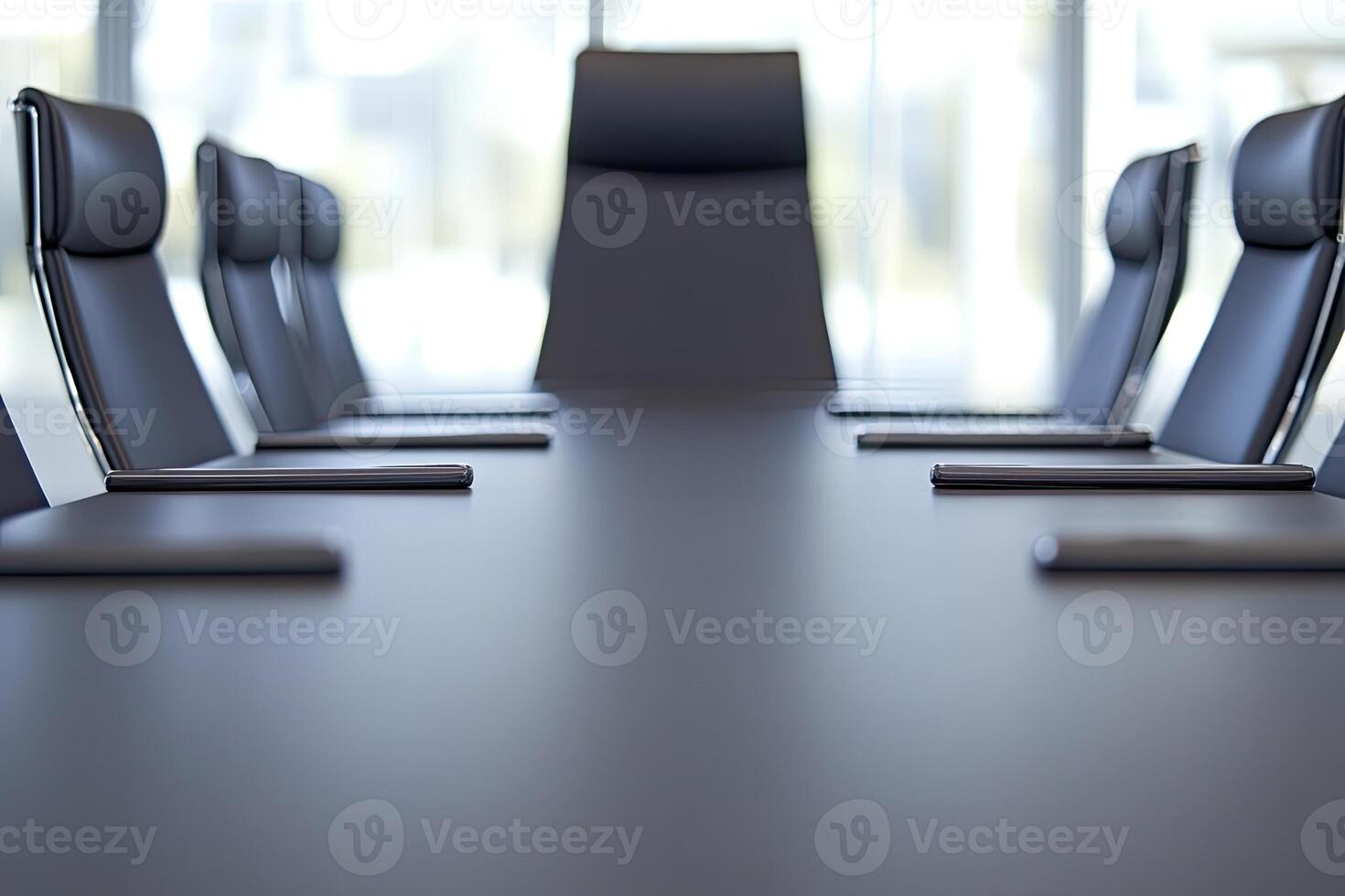 A conference table with black chairs and a large window photo