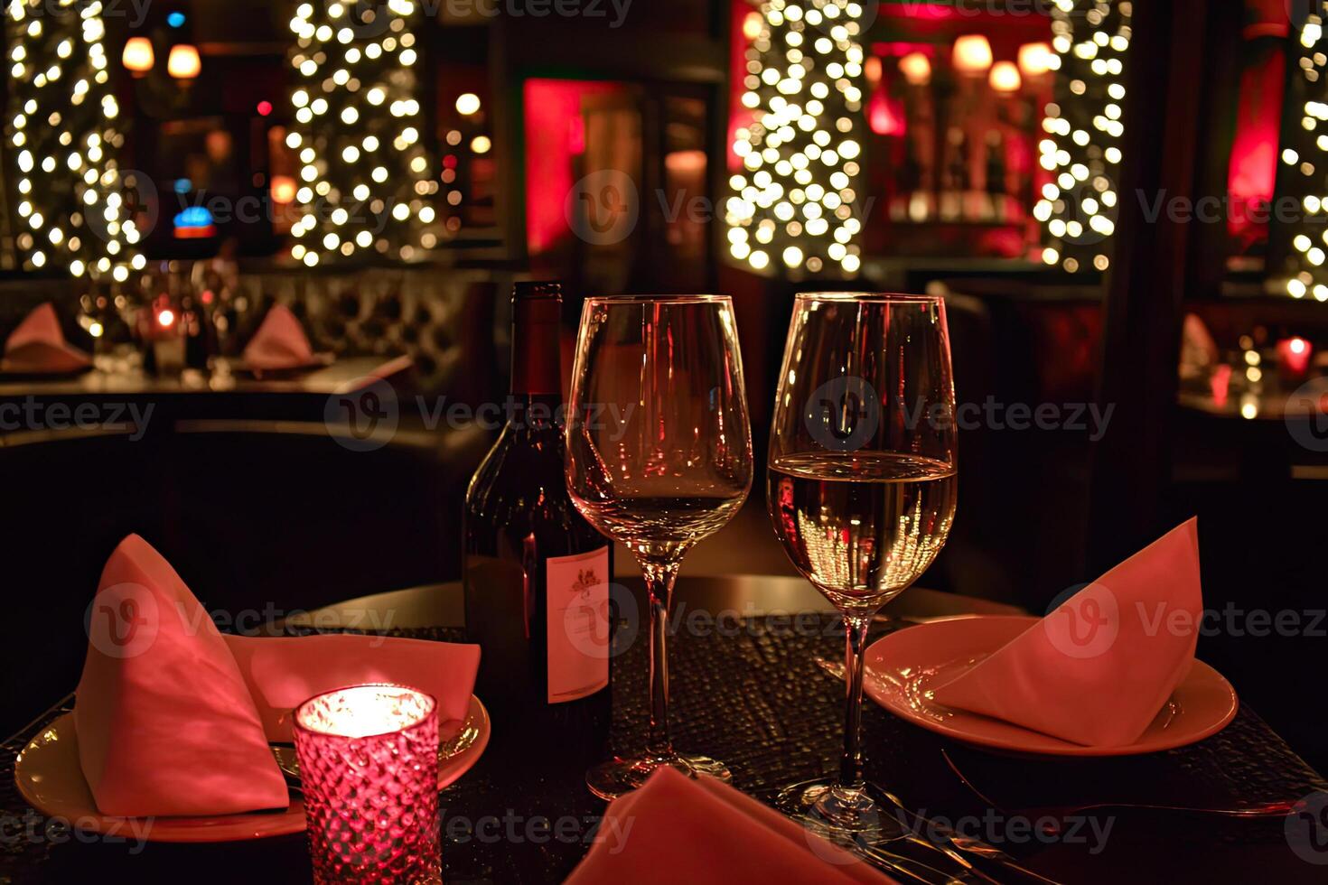 A table with two wine glasses and a plate of food photo