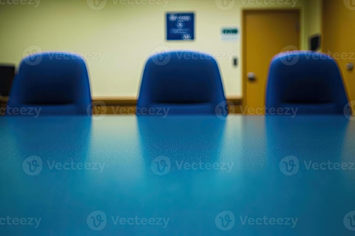 A conference table with blue chairs in front of it photo