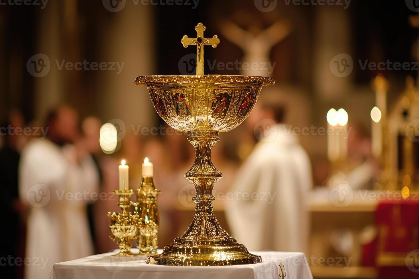 A gold chalice with a cross on top of it photo