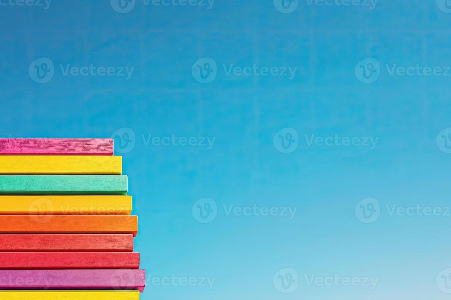 A stack of colorful books against a blue sky photo