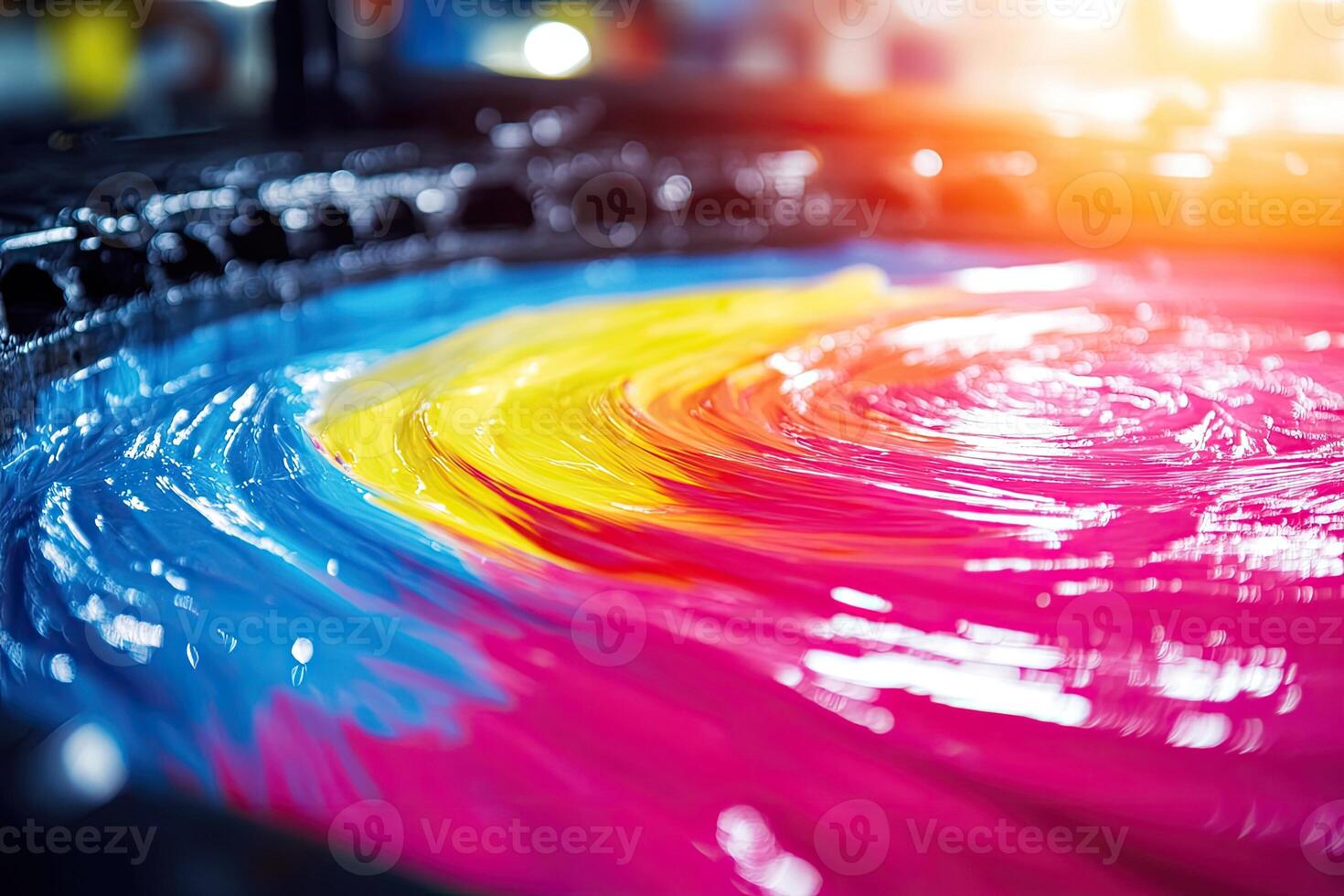 A large bowl of colorful ink is being poured into a machine photo