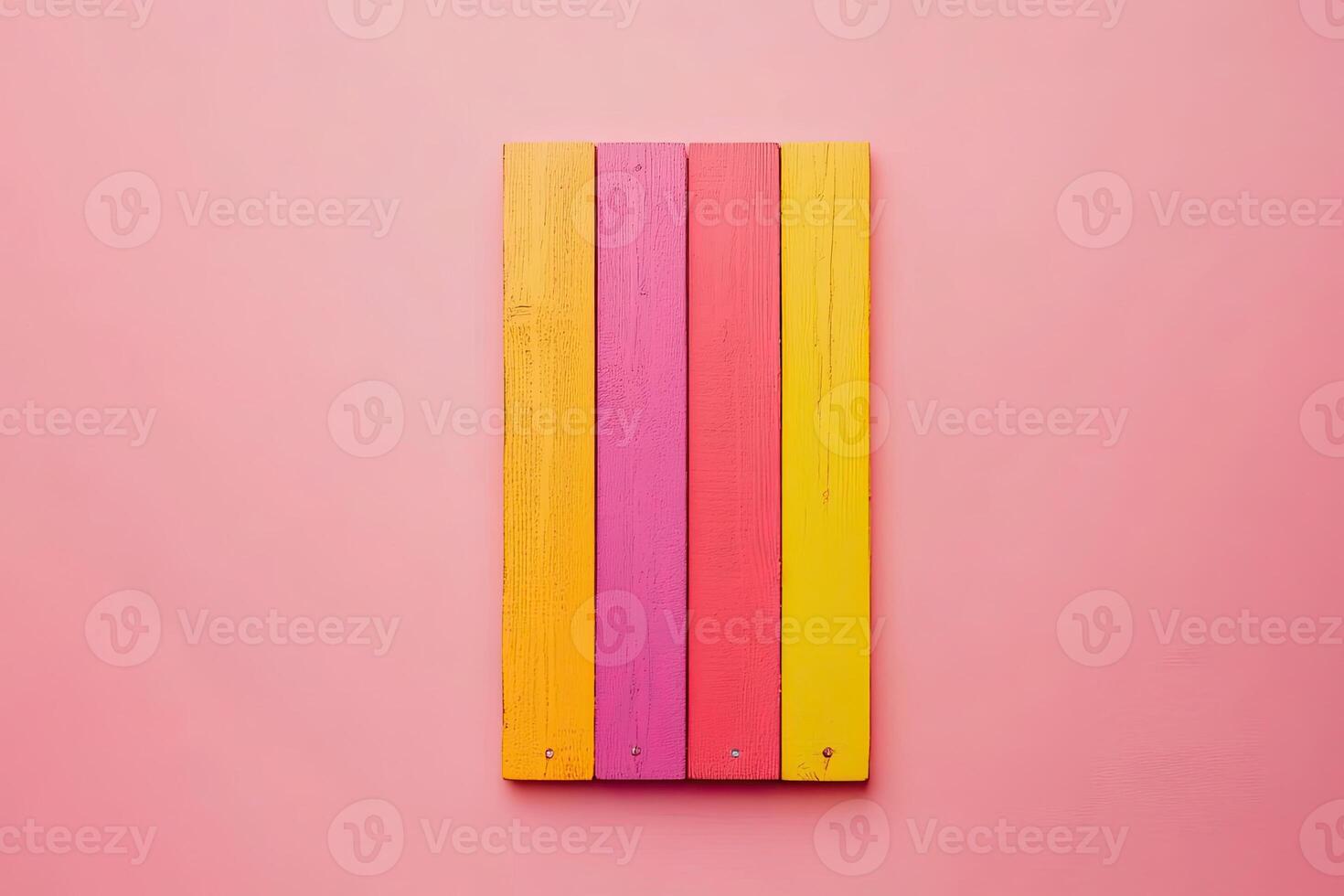 A rainbow colored pencil on a pink background photo