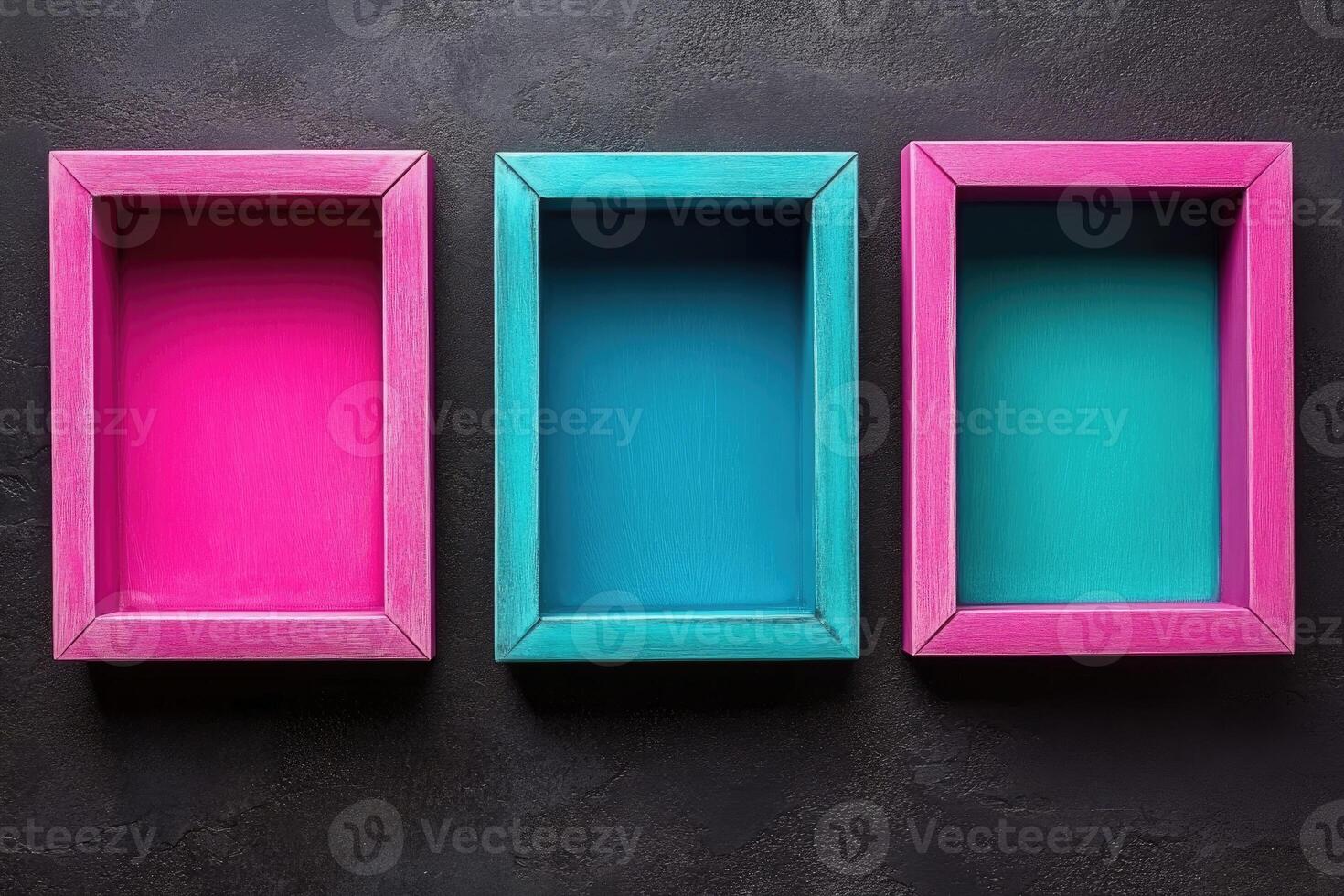 Three wooden boxes with different colors on a black background photo