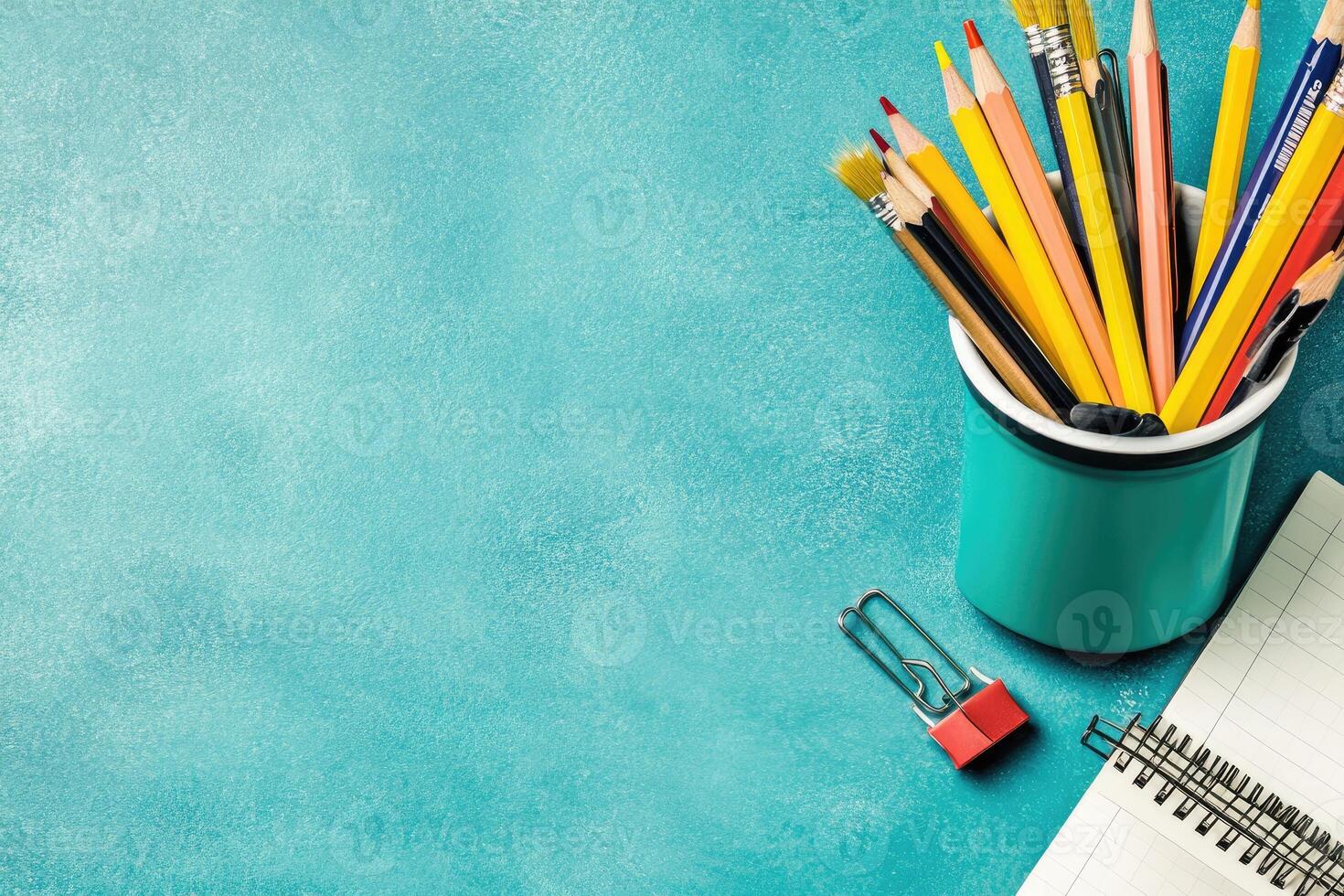 School supplies and pens on a blue background photo