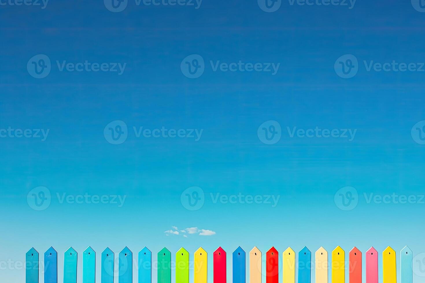 A colorful fence with a bench in the middle photo