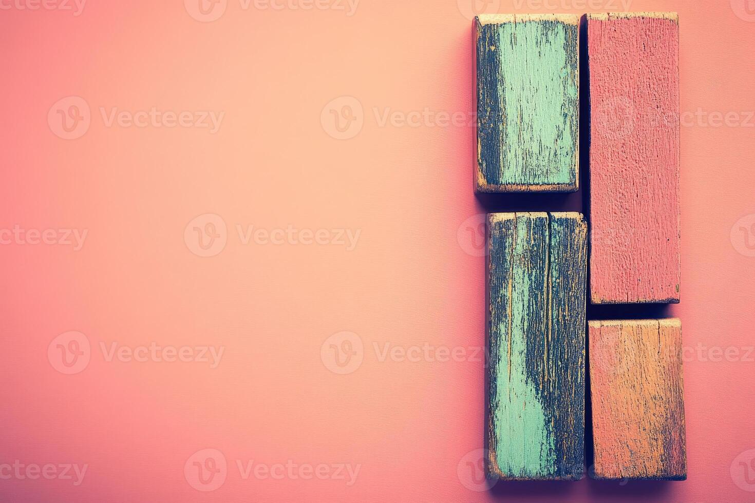 Colorful wooden blocks on a pink background photo