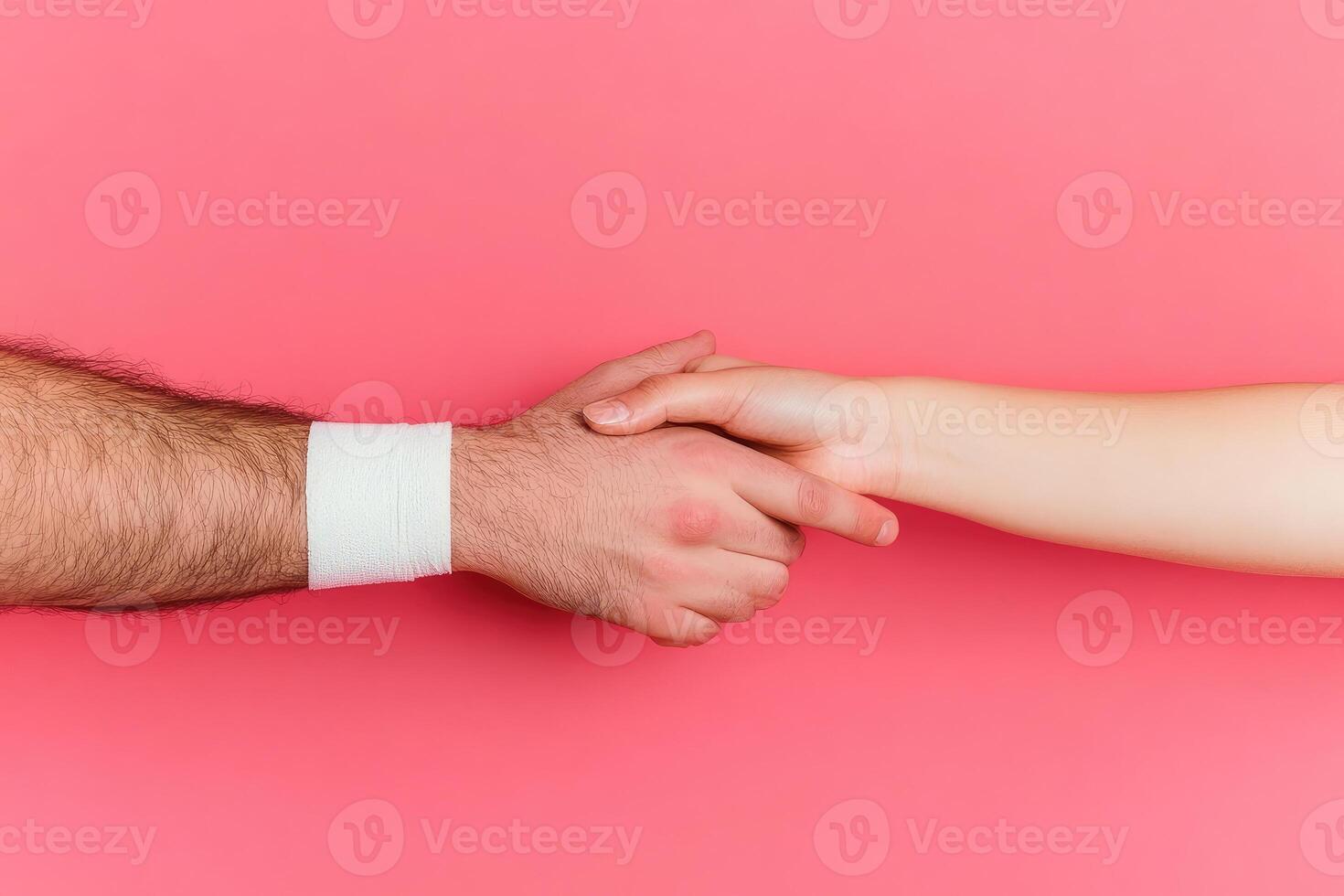 A handshake on a pink backdrop photo