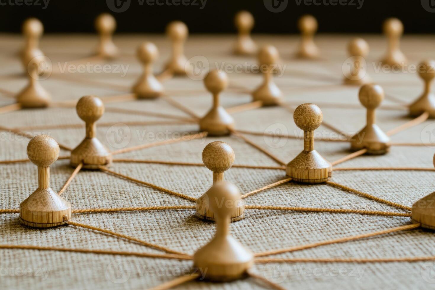 Network of interconnected individuals. Wooden figures connected by threads, creating a complex network photo