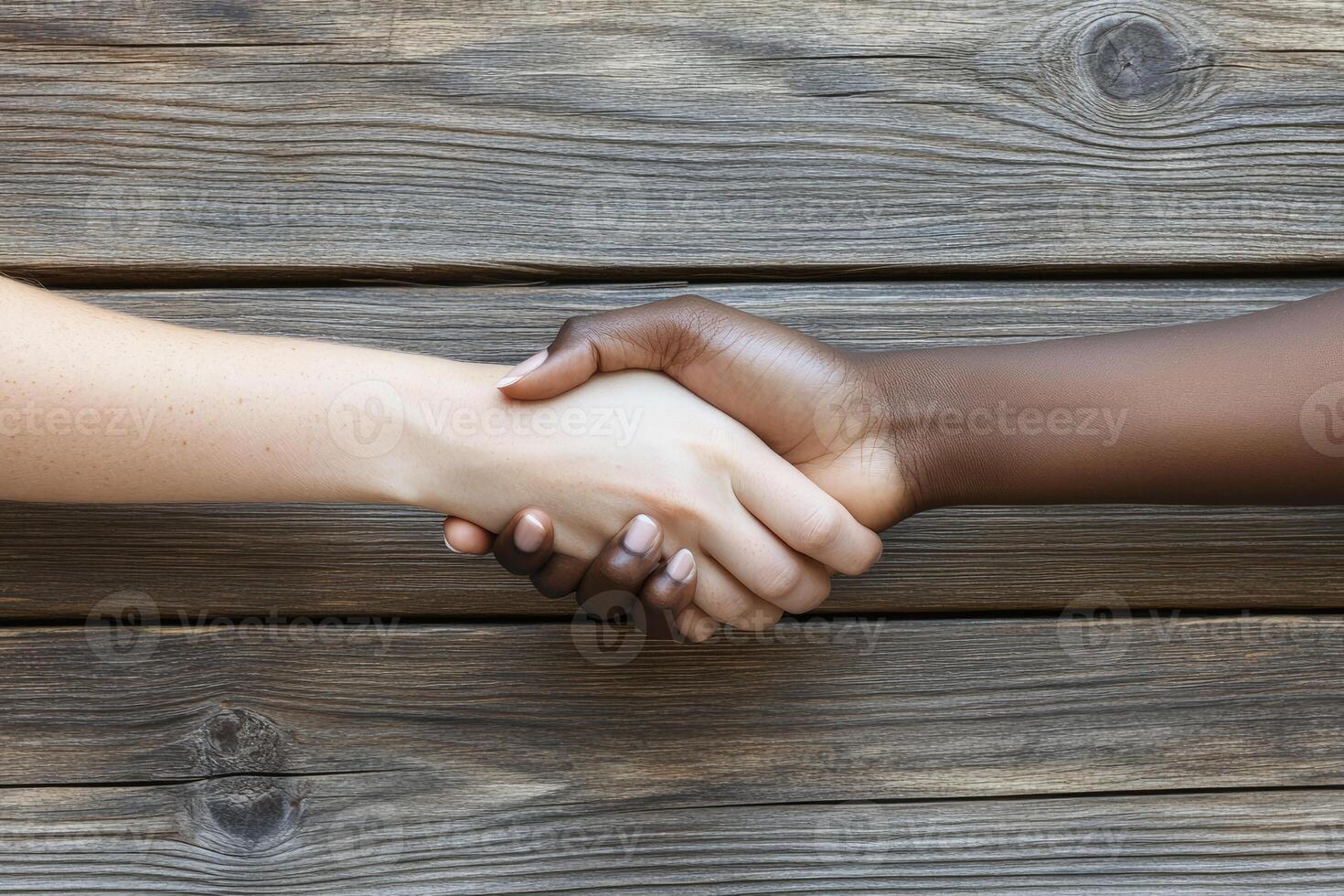 Diverse hands shake in agreement photo