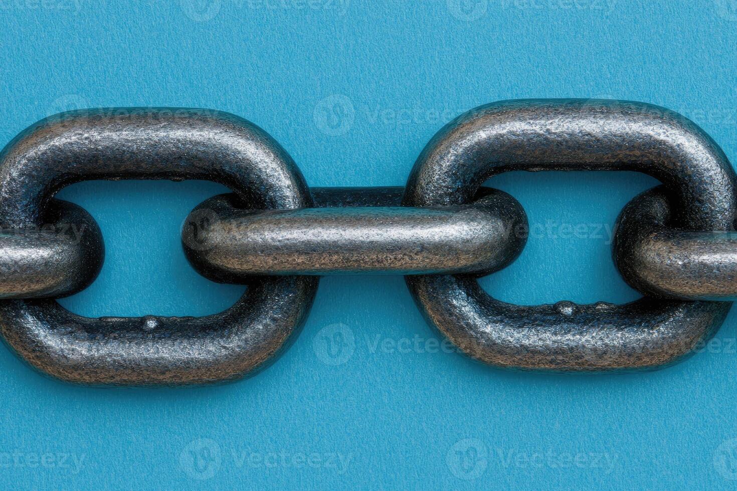 Close-up of a heavy-duty metal chain link against a vibrant blue backdrop. The links are robust and interlocking, showcasing industrial strength photo
