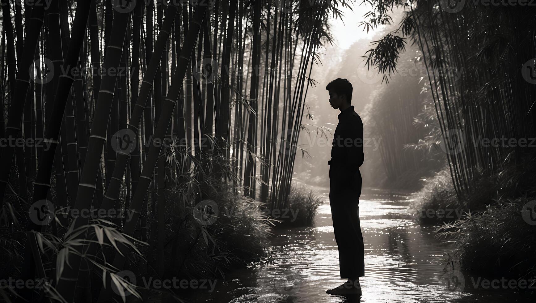 Person Standing in Stream Surrounded by Bamboo Forest in Grayscale photo