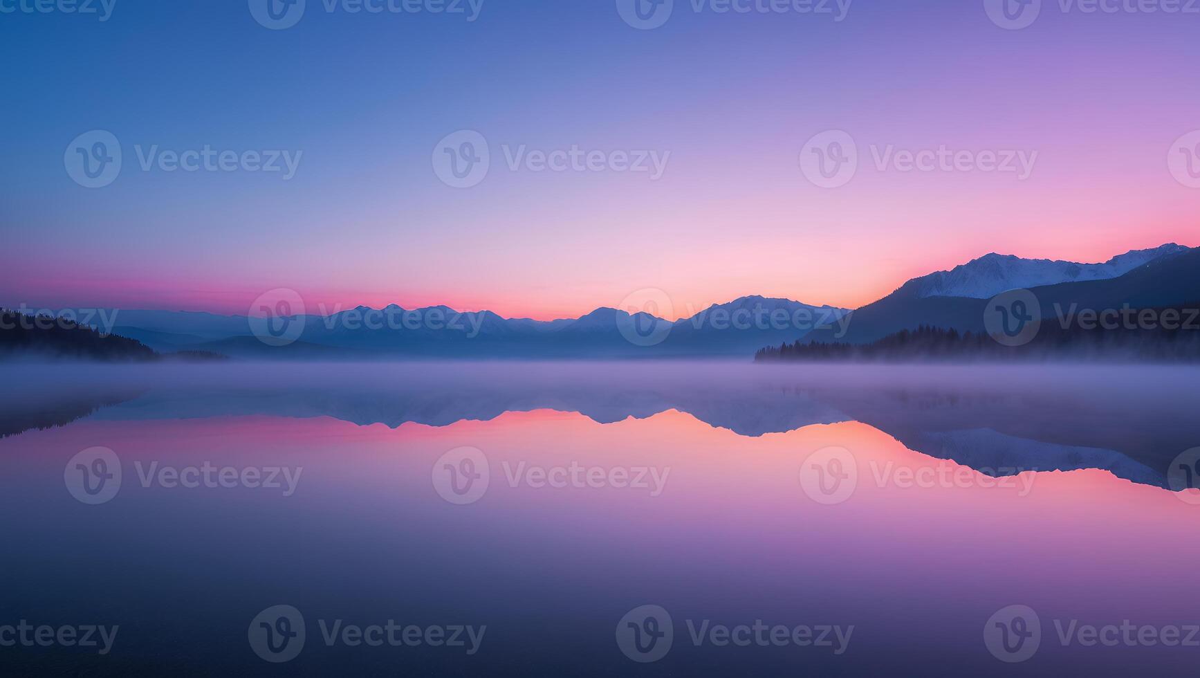 Calm Lake Reflecting Mountains at Dawn with Colorful Sky and Fog photo