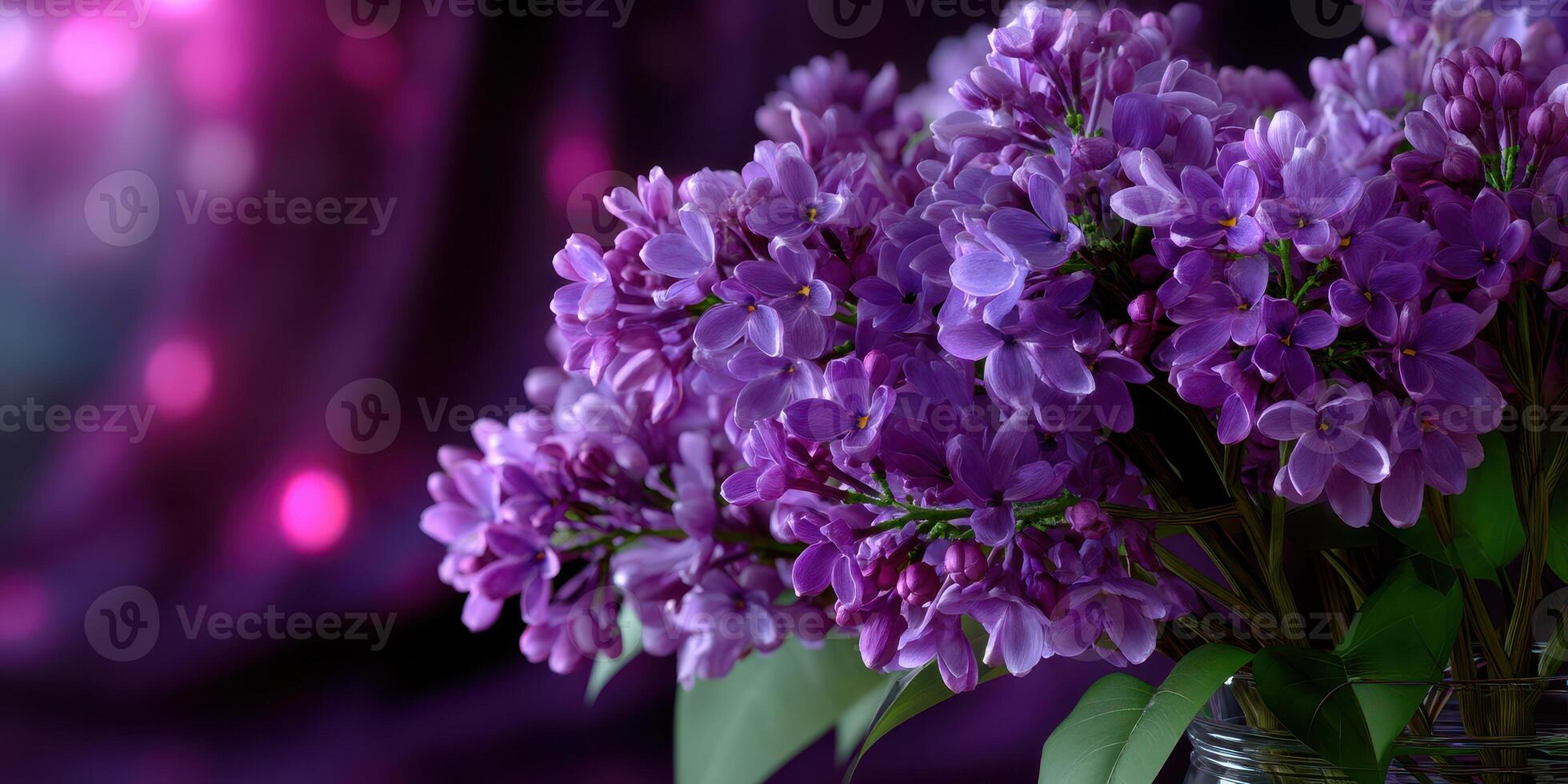 Vibrant purple lilacs in a glass jar against a rich purple background creating an elegant atmosphere for any setting photo