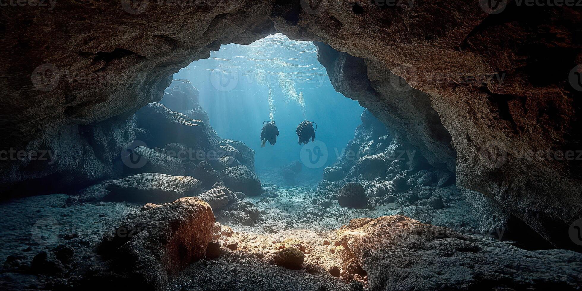 Divers explore an underwater cave illuminated by sunlight in a tranquil marine environment photo